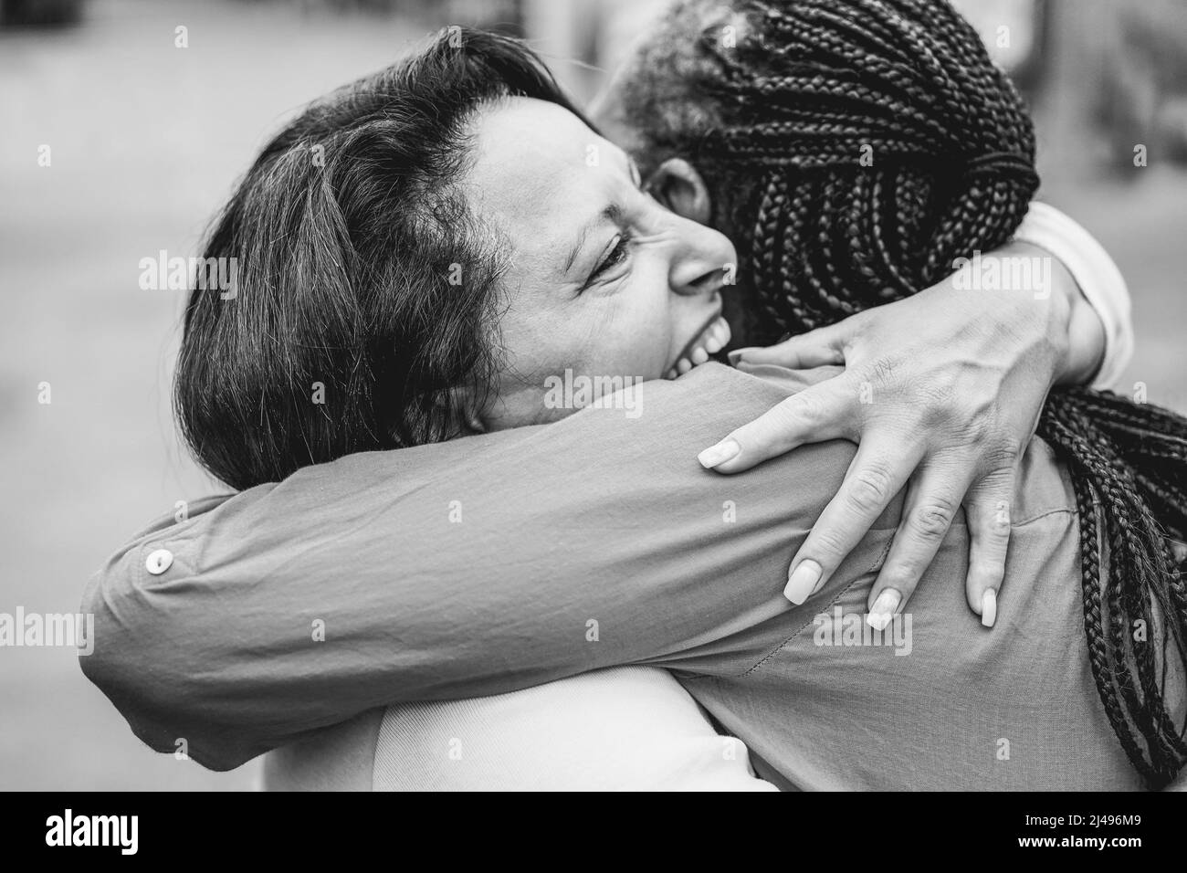 Senior multiracial women meeting and hugging each others outdoor ...