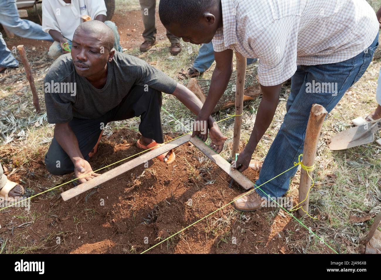 Umuganda monthly community service. Here they are working on construction of classrooms for 12 years basic education at the Mwurire Groupe Scolare school, Mbazi sector, Huye District.  Photograph by Mike Goldwater Stock Photo