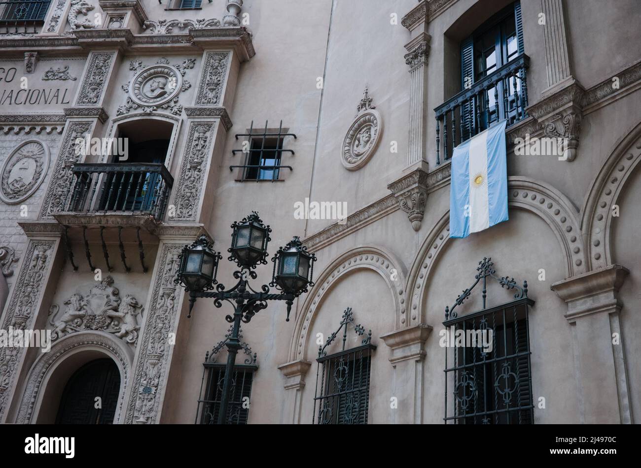 Facade of Banco Hipotecario Nacional building where is also located Ministry of Culture of Mendoza province, Argentina. Argentinian flag on facade Stock Photo