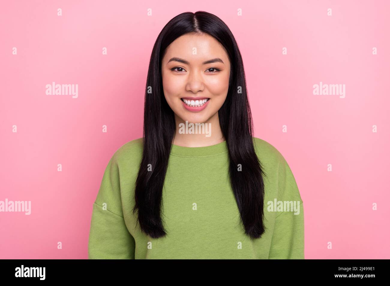 Photo of cute brunette young lady wear green sweater isolated on pink color background Stock Photo