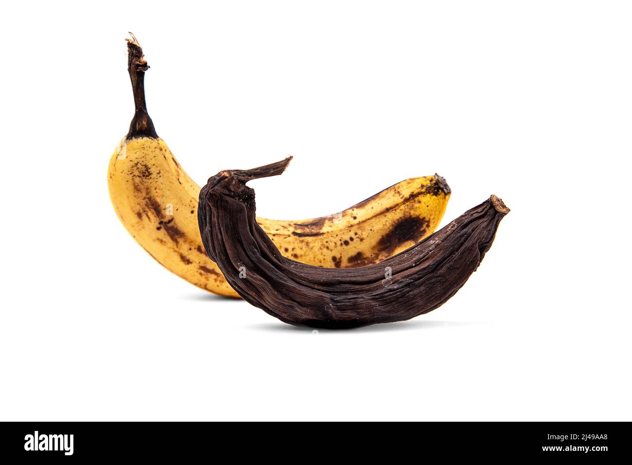 Ripe and dried bananas in the peel isolated on a white background Stock Photo