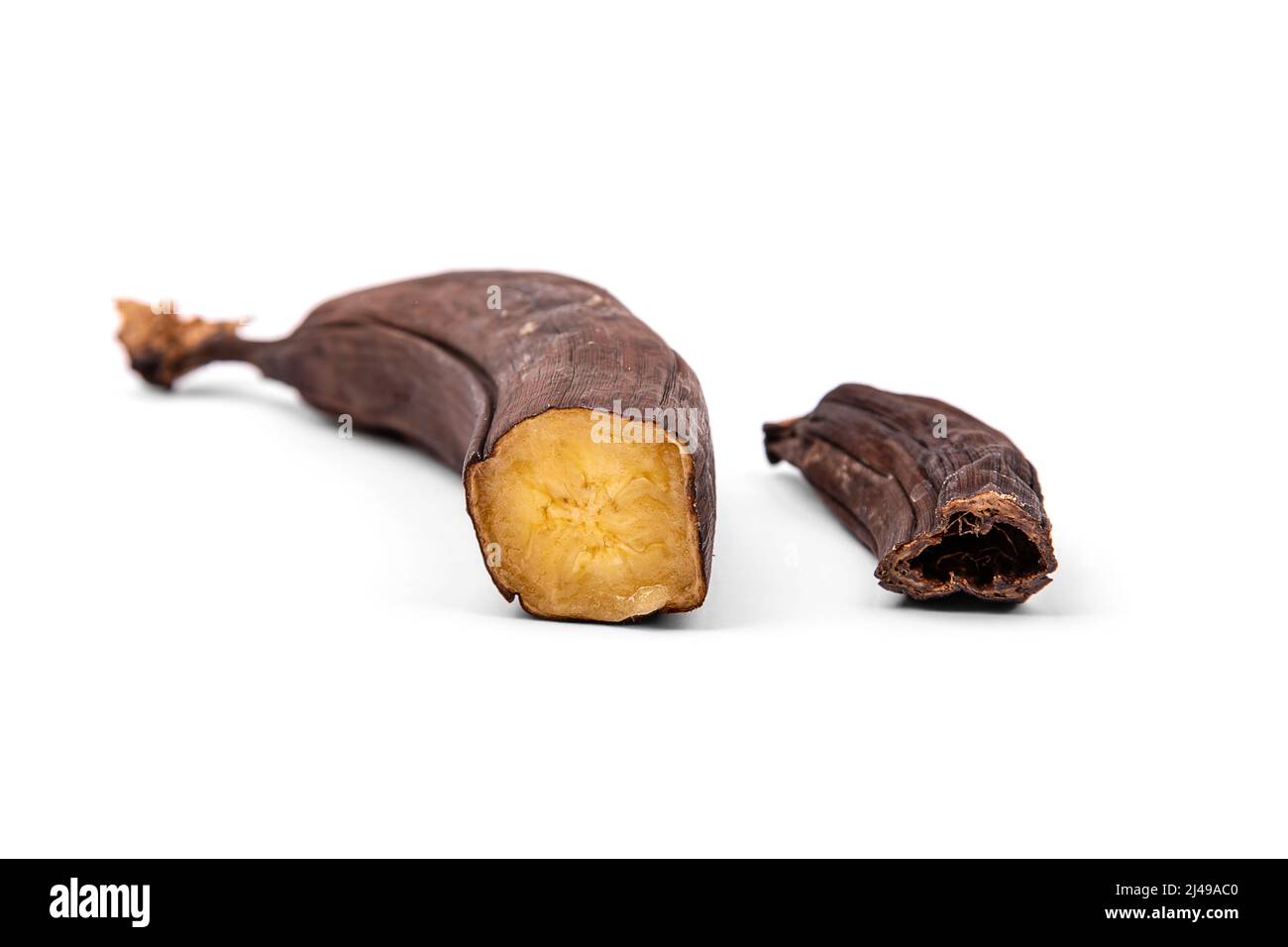 Overripe and dried bananas in section isolated on a white background Stock Photo
