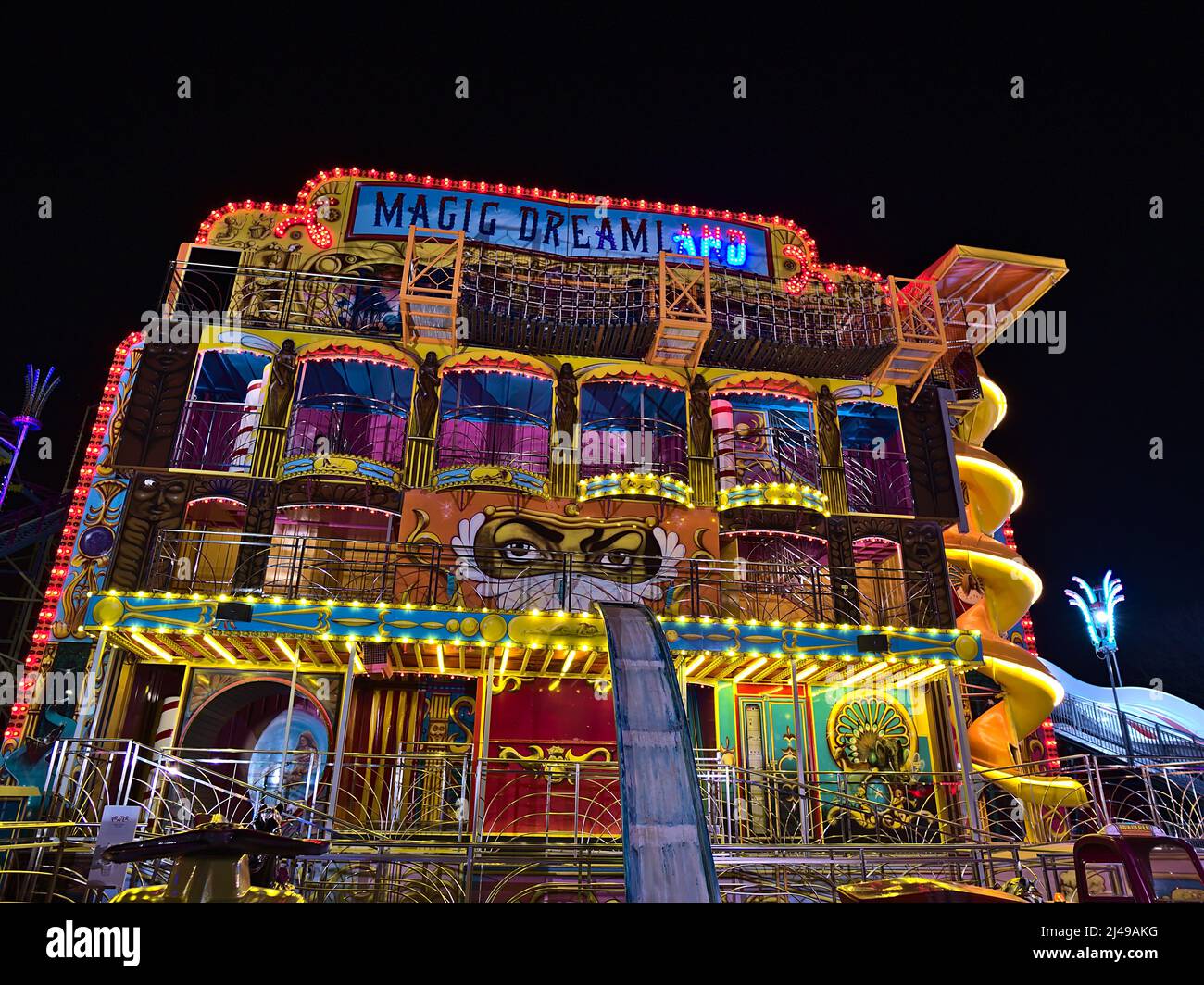 View of amusement park ride 'Magic Dreamland' in Wurstelprater near Wiener Prater in Vienna, Austria in the dark night with colorful lights. Stock Photo