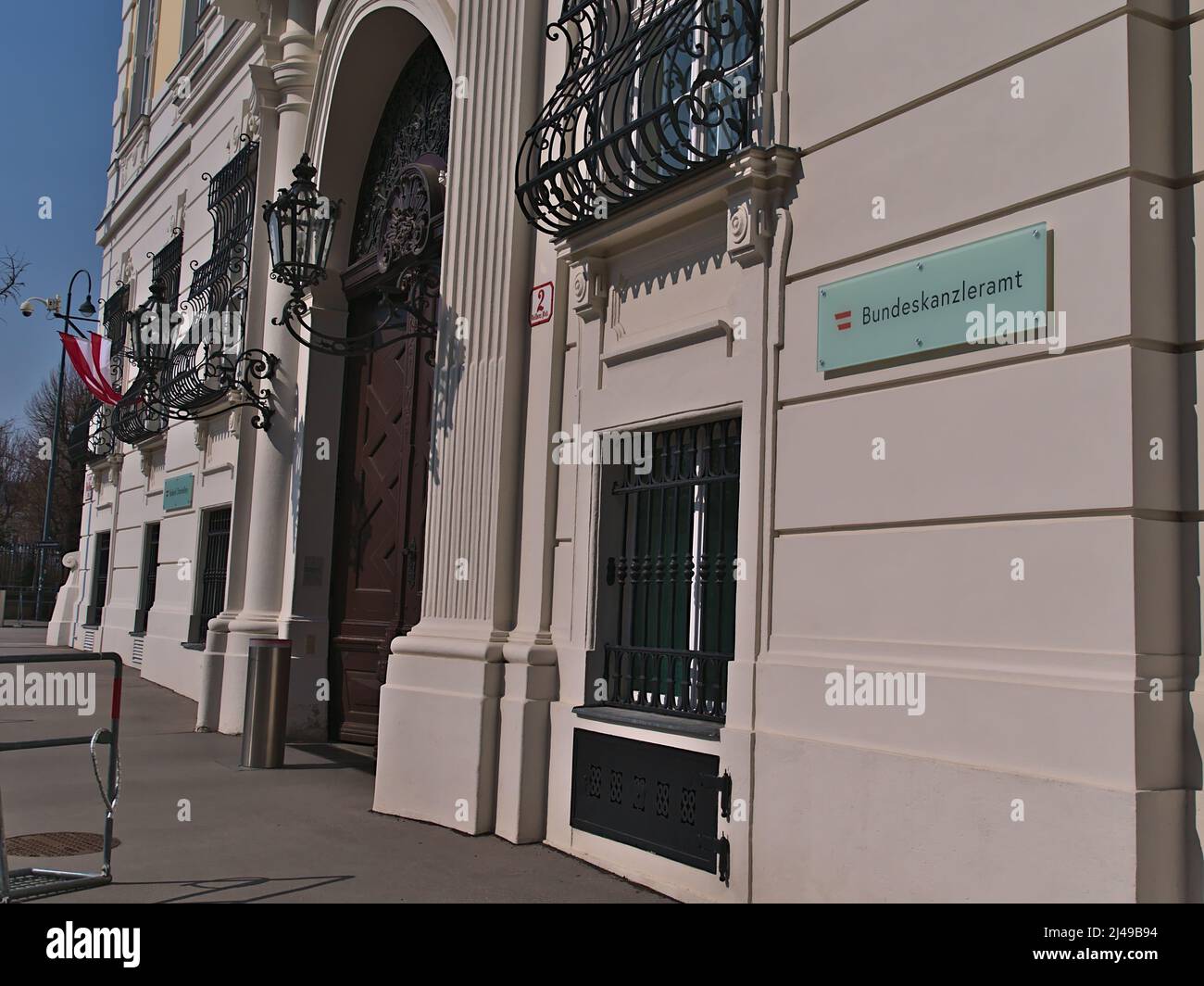 View of the entrance of Bundeskanzleramt (BKA), Chancellery of Austria, in the center of Vienna in historic building with flags and sign on the wall. Stock Photo