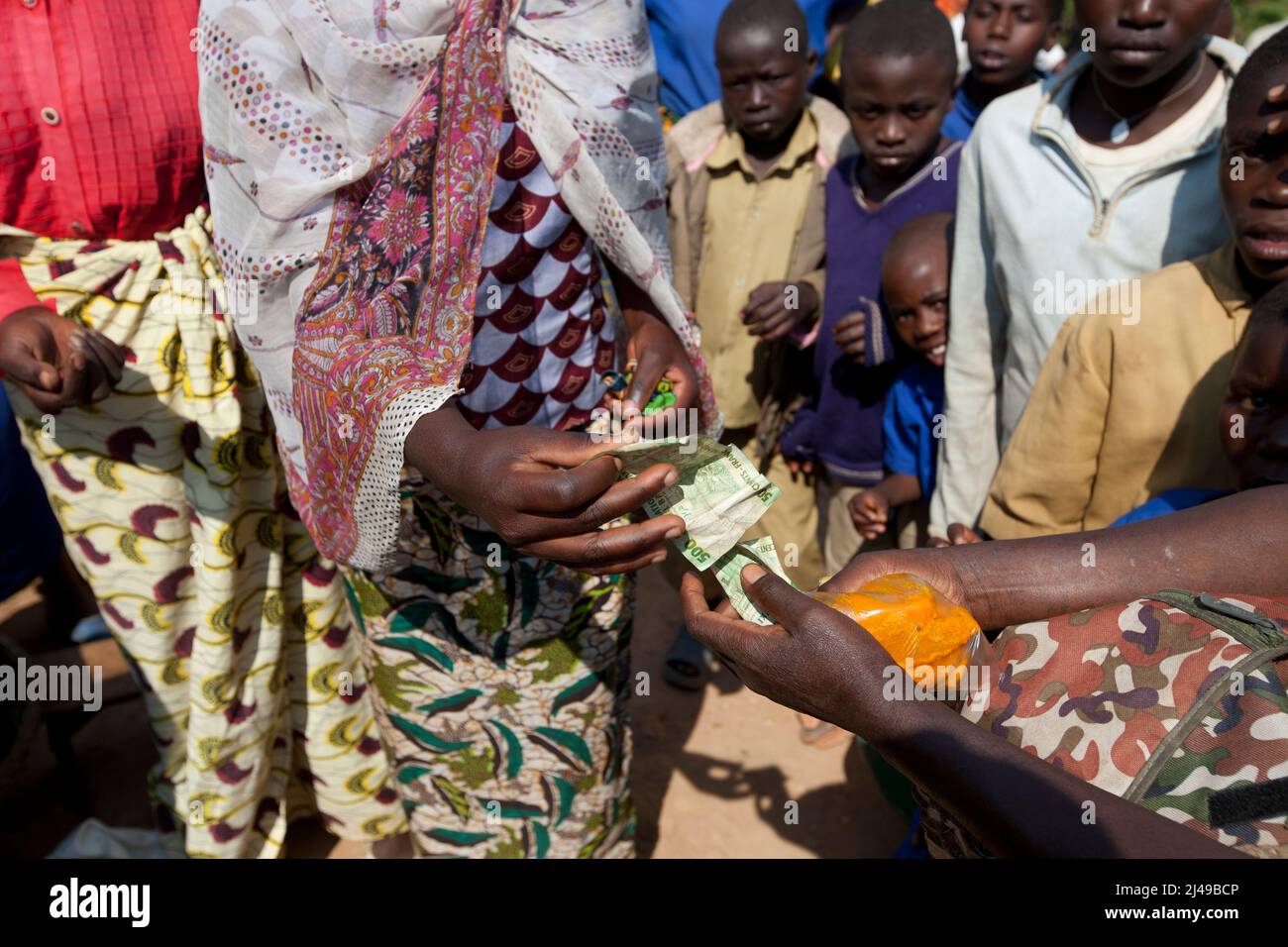 Zainab Nyirazirwanda, 45, a widow whose husband died in 1994.  She has two children, Shadia Nzayisenga, daughter, 20 and son Issa Tuzimana, 17 and grandson, Maniraguha, 2.    Before the programme her farming produced very little. Now from the proceeds of her farming she has bought a cow, chickens, goats. She bought land to farm maize and she sells salt and palm oil in the market.   She bought a cell phone and sends her son to secondary school.  Photograph by Mike Goldwater Stock Photo