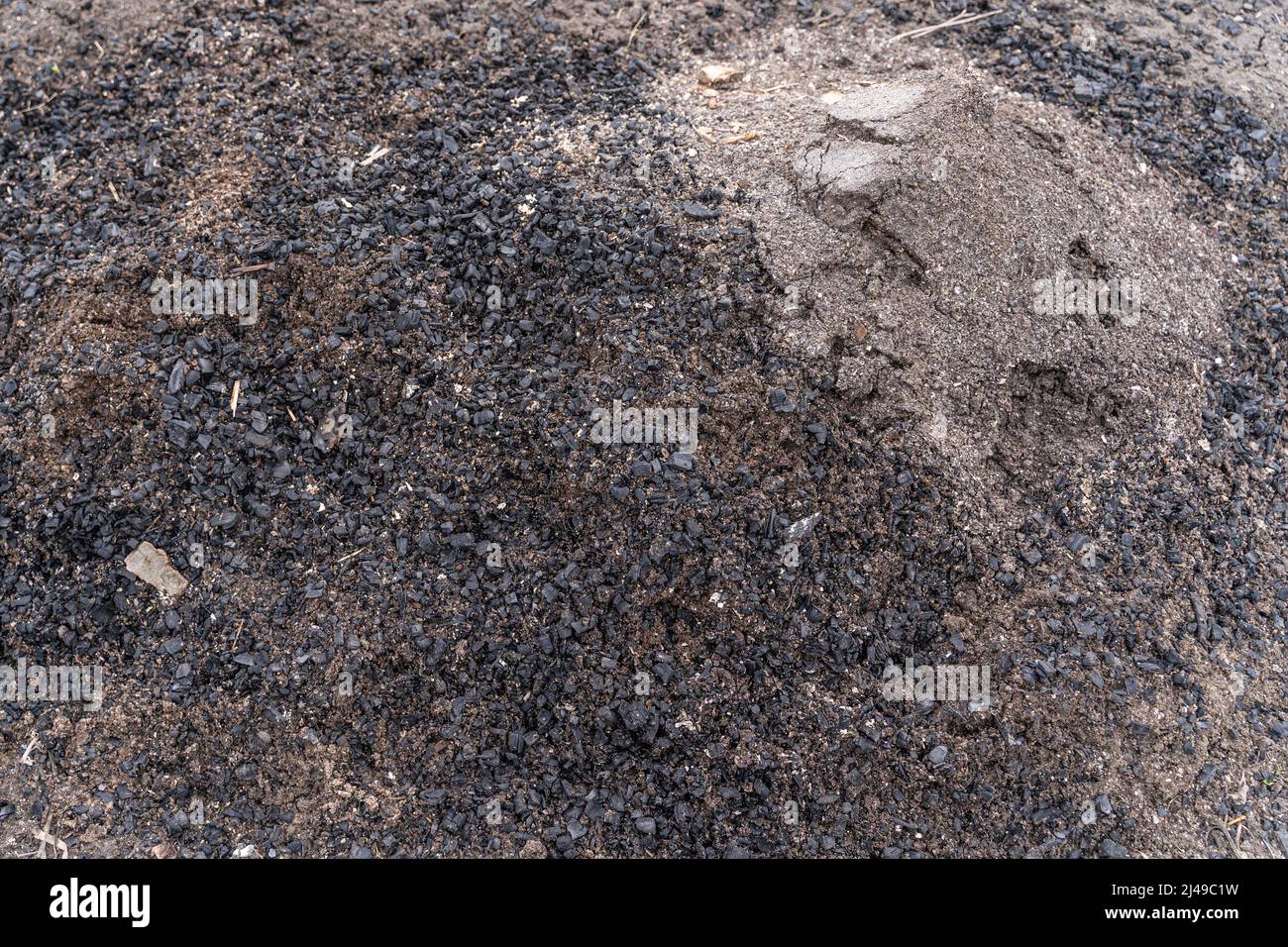 Ash and coal from burnt firewood are poured out in the garden