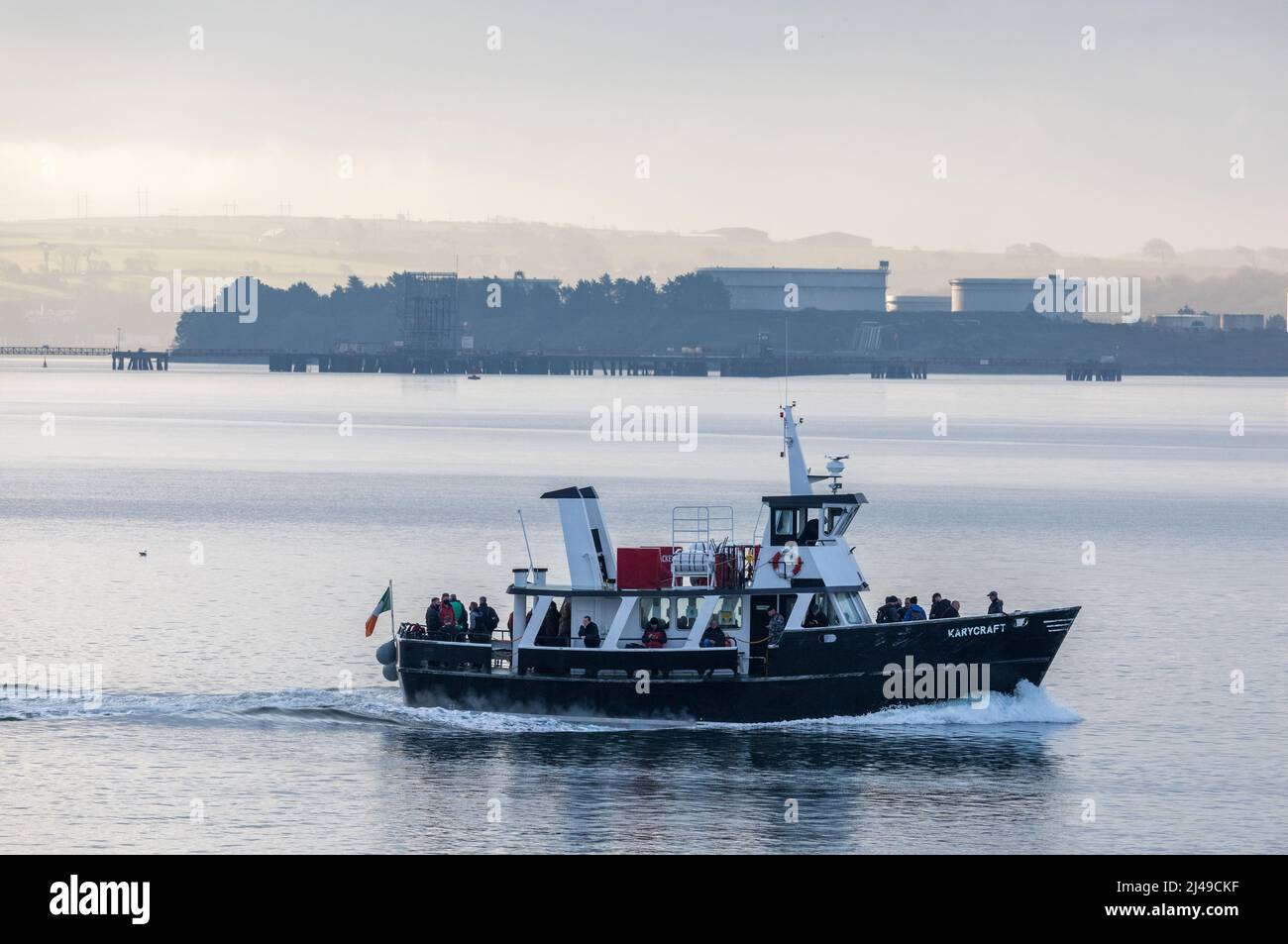 Cobh, Cork, Ireland. 13th April, 2022. Ferry boat Karycraft passes the storage tanks at the oil refinery carrying Naval Service personnel to their base in Haulbowline from Cobh, Co. Cork, Ireland. - Credit; David Creedon / Alamy Live News Stock Photo
