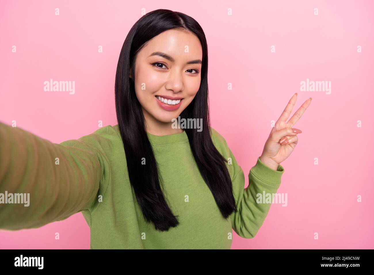 Photo of cool young lady do selfie show v-sign wear green sweater ...