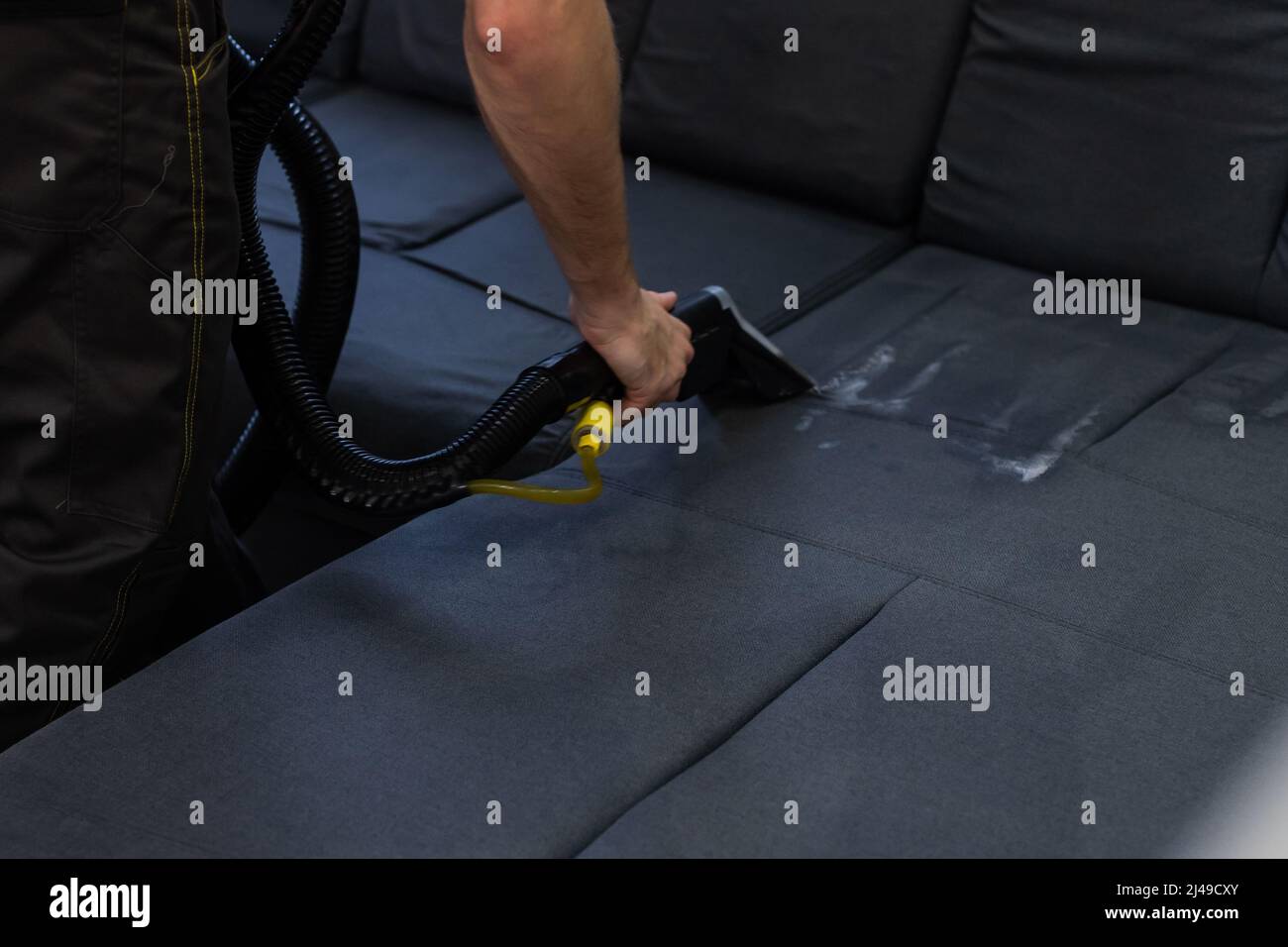 Hand cleaning a sofa with a steam cleaner, Home cleaning concept Stock ...