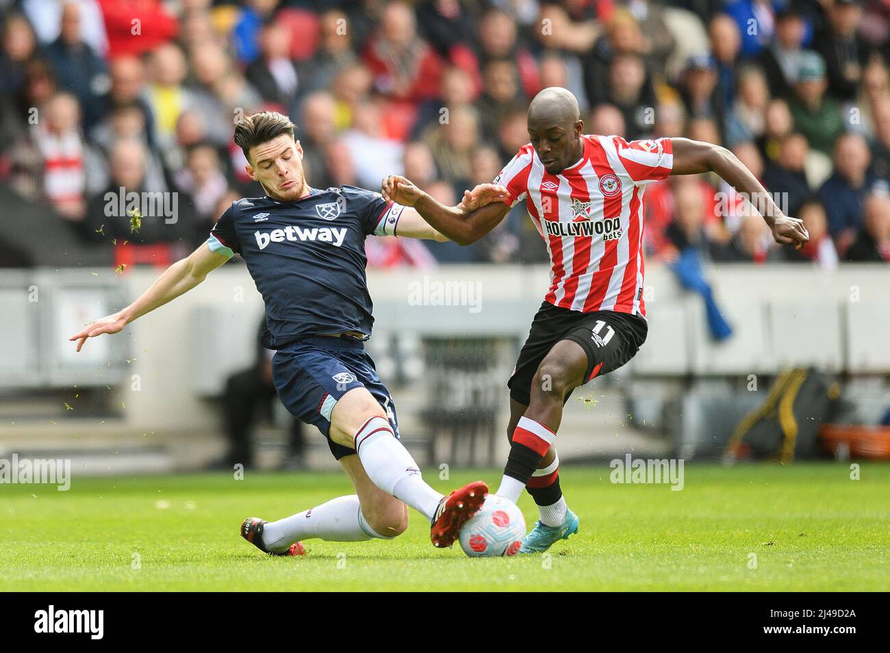 10 April 2022 - Brentford v West Ham United - Premier League - Brentford Community Stadium  Declan Rice tackles Yoanne Wissa during the match at the B Stock Photo