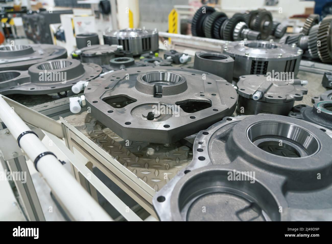 Vehicle metal parts in factory. Production line for assembly industrial tractors. Stock Photo