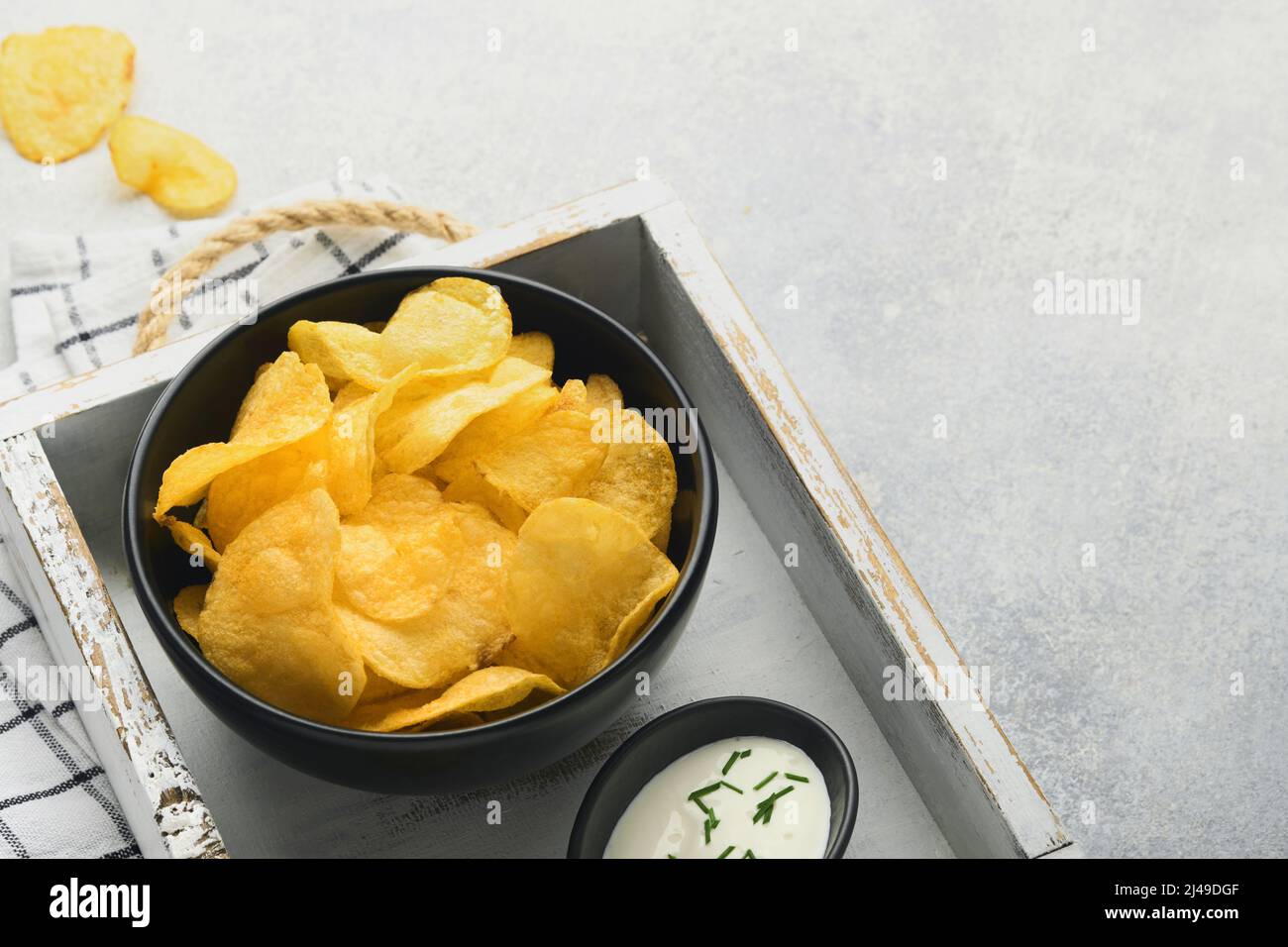 Potato chips. Fast food. Crispy potato chips ceramic black bowl with