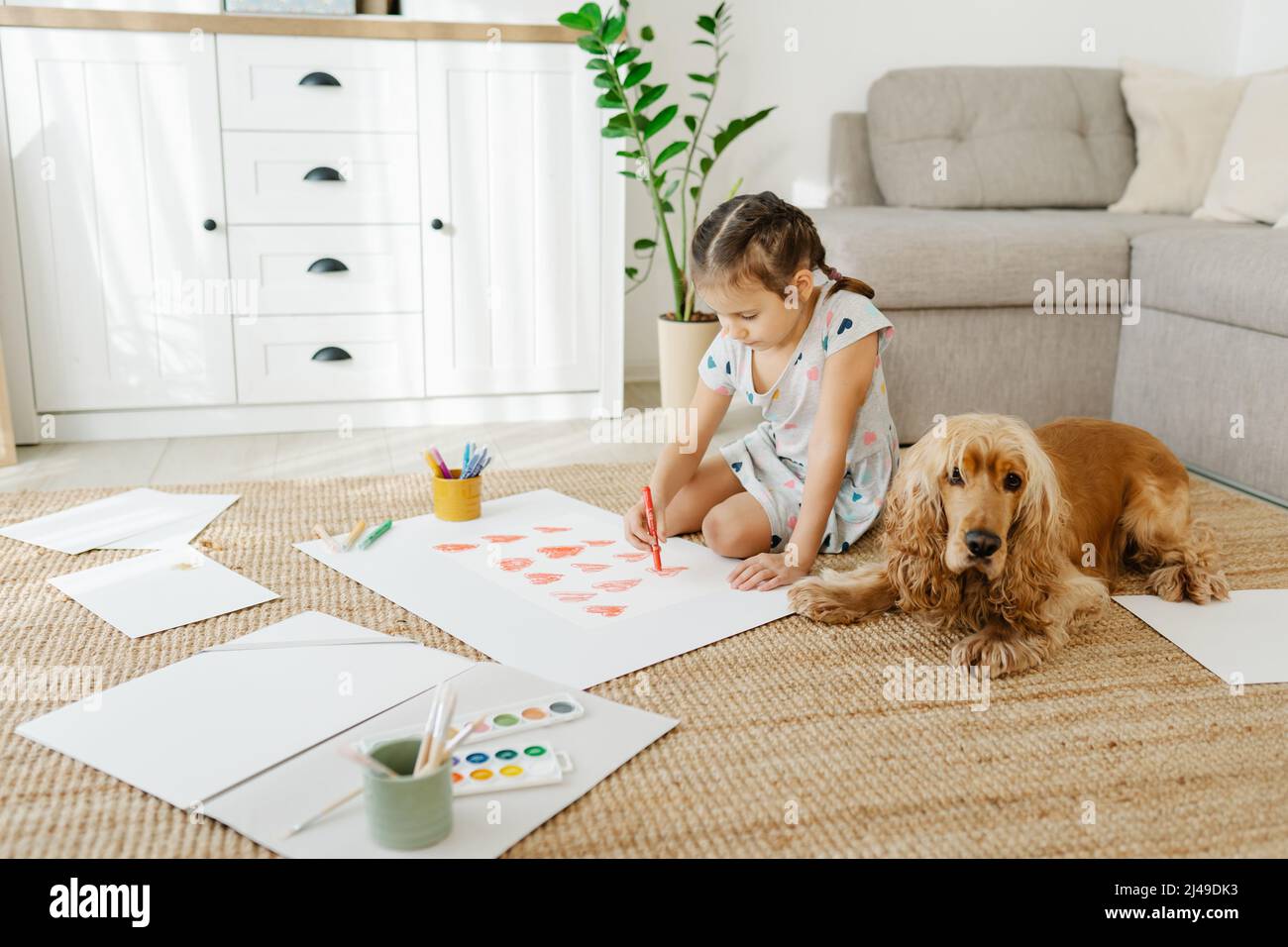Child drawing hearts on paper. Art therapy Stock Photo