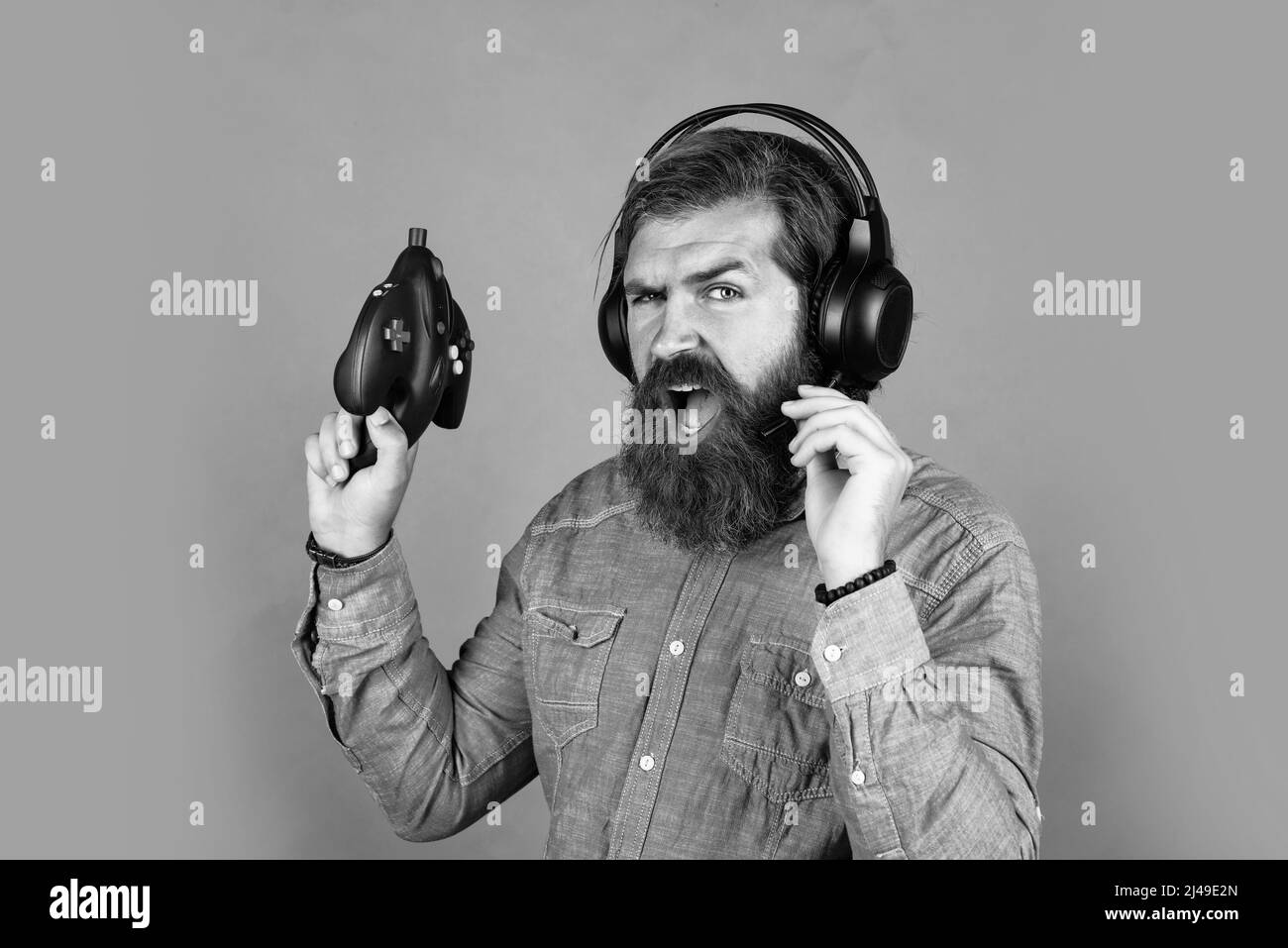 on higher level. online game. concept of tv gaming. man in headphones with console. hobby. just have fun. new technology in modern life. happy gamer Stock Photo