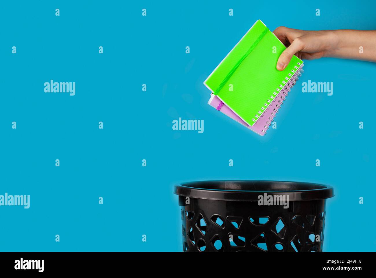 Notebooks are thrown in the trash can. For copy space for designers on