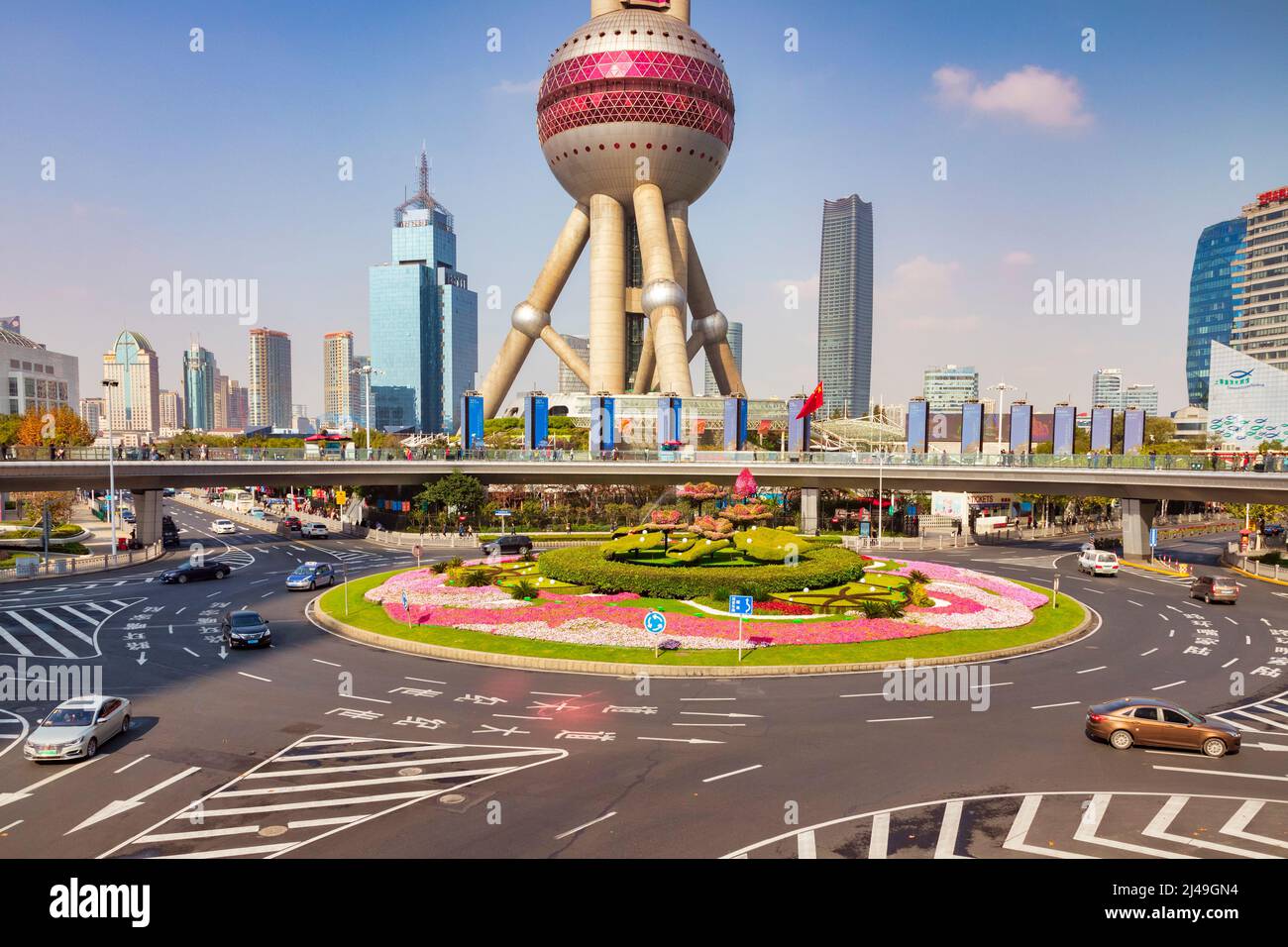 1 December 2018: Shanghai, China - A view of the Pudong district, with the Oriental Pearl Tower, and a large roundabout with topiary in the middle. Stock Photo
