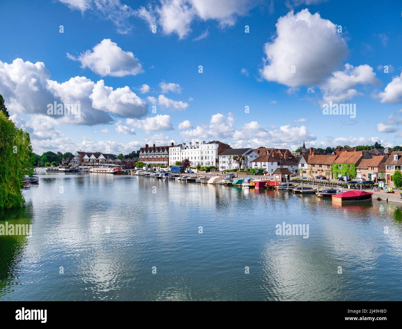6 June 2019: Henley on Thames, UK - The River Thames, where it is lined by beautiful old buildings, with summer sky reflected in the water. Stock Photo