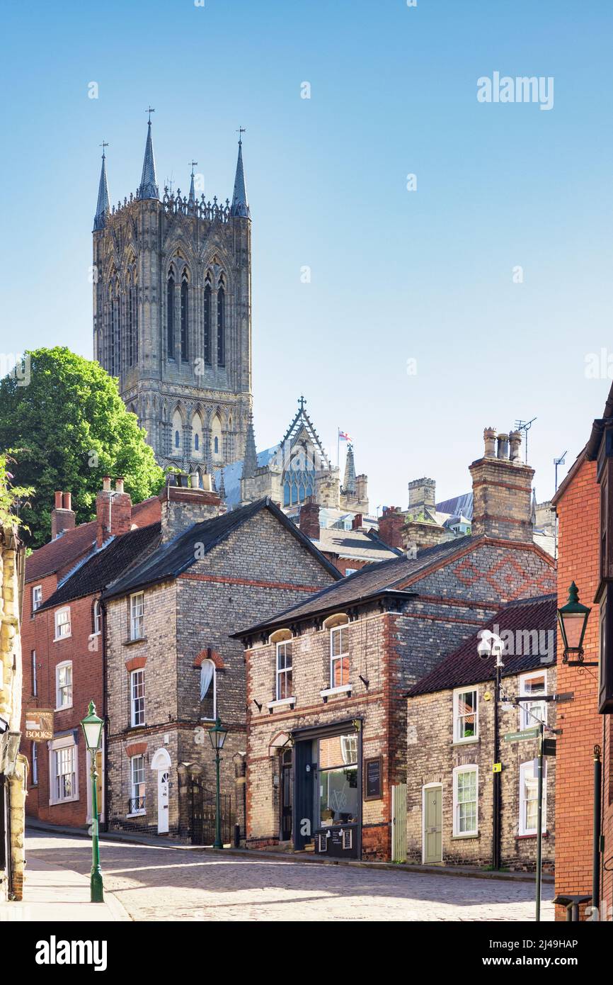 2 July 2019: Lincoln, UK - Steep hill, the city's famous medieval street, and Lincoln Cathedral, on a bright sunny morning. Stock Photo