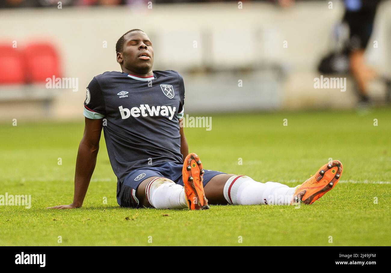 10 April 2022 - Brentford v West Ham United - Premier League - Brentford Community Stadium  Kurt Zouma goes down injured during the match at the Brent Stock Photo