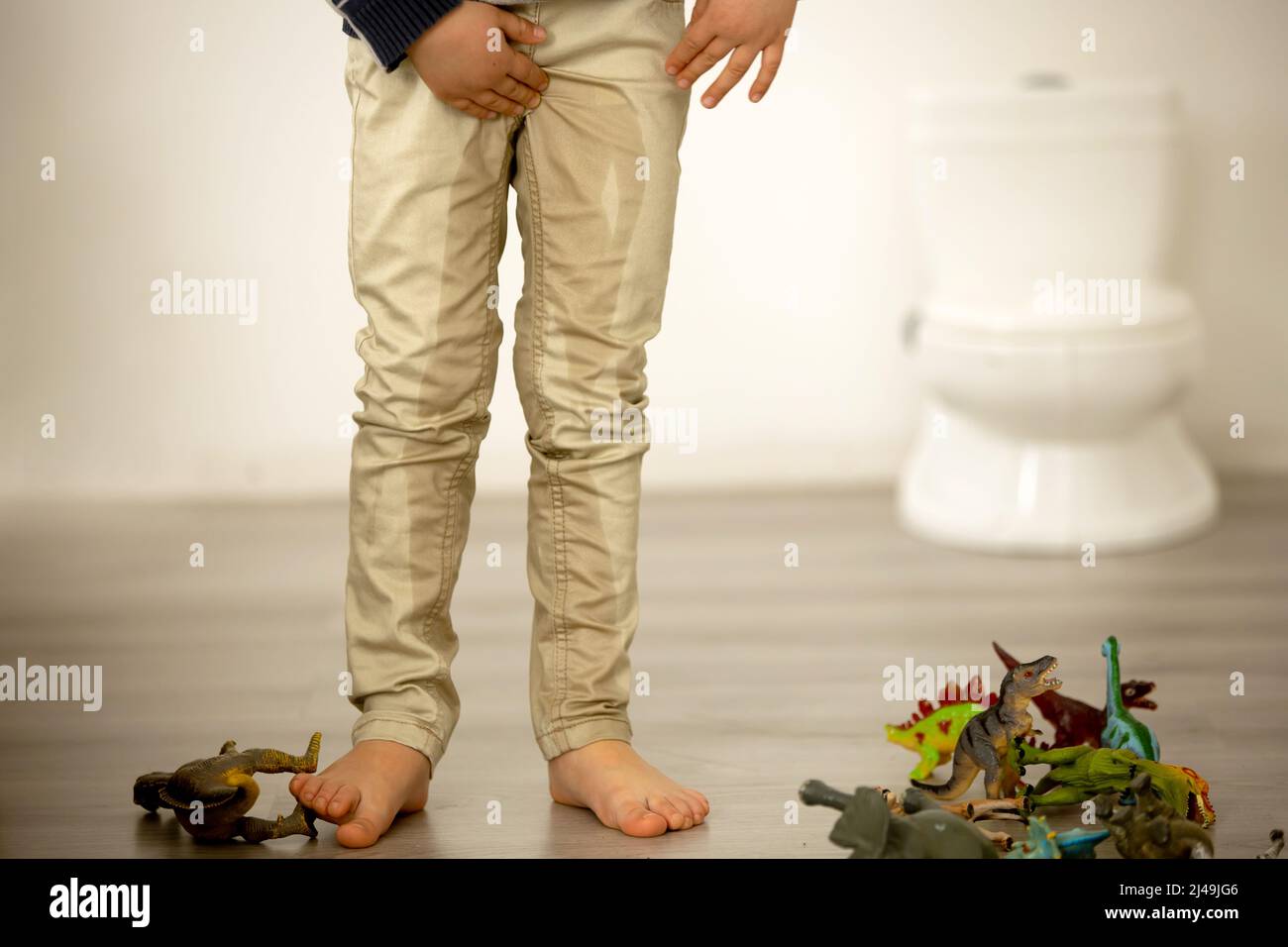 Little toddler child, boy, pee in his pants while playing with toys