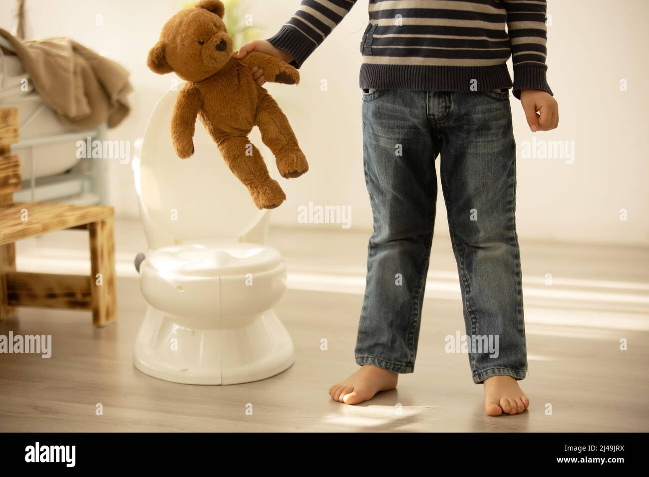 Little toddler child, boy, pee in his pants while playing with toys