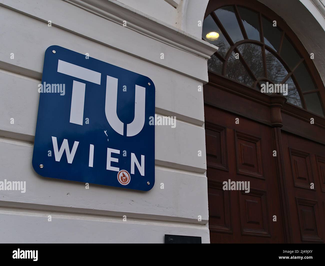Closeup view of the blue and white colored logo of TU Wien (Vienna University of Technology) on the main building in the downtown of Vienna, Austria. Stock Photo