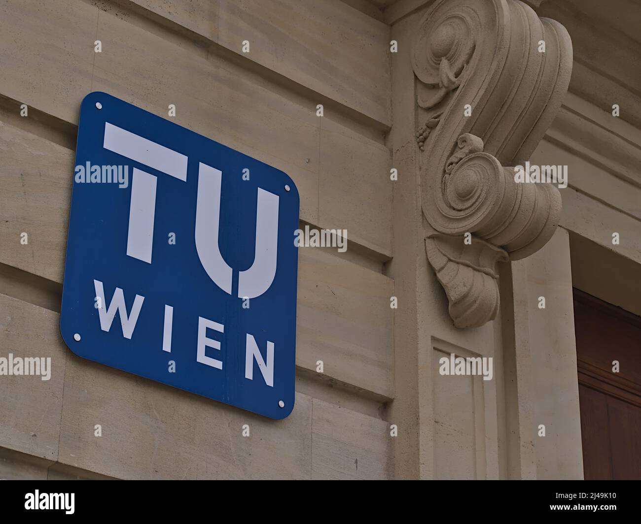 Closeup view of the blue and white colored logo of TU Wien (Vienna University of Technology) on the campus in the downtown of Vienna, Austria. Stock Photo