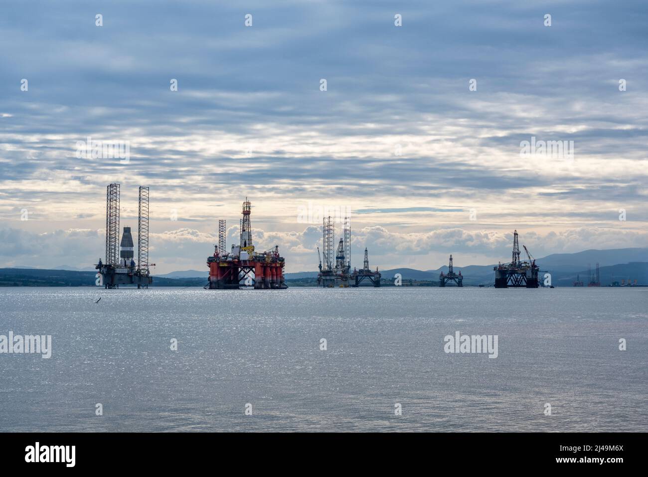 Oil rigs / drilling platforms moored in Cromarty Firth viewed from village of Nigg on Easter Ross Peninsula, Ross and Cromarty, Highland, Scotland, UK Stock Photo