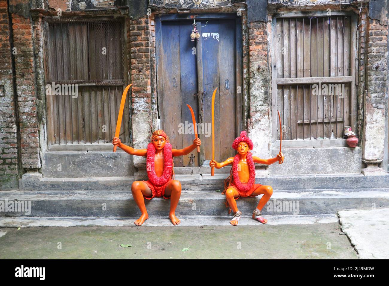 April 13, 2022, Munshiganj, Dhaka, Bangladesh: Hindu Devotees took part in the annual Lal Kach (Red Glass) festival in Munshiganj, Bangladesh to welcome Bangla new year. During the Hindu Lal Kach festival, children and men paint themselves with red color and attend a procession holding swords as they show power against evil and welcome the Bengali New Year. The Lal Kach festival is well known for the local community for more than hundred years. As the month of Chaitra, the last in the Bangla year, draws to an end, the Hindu community comes together in a festival dedicated to the worship of Lor Stock Photo