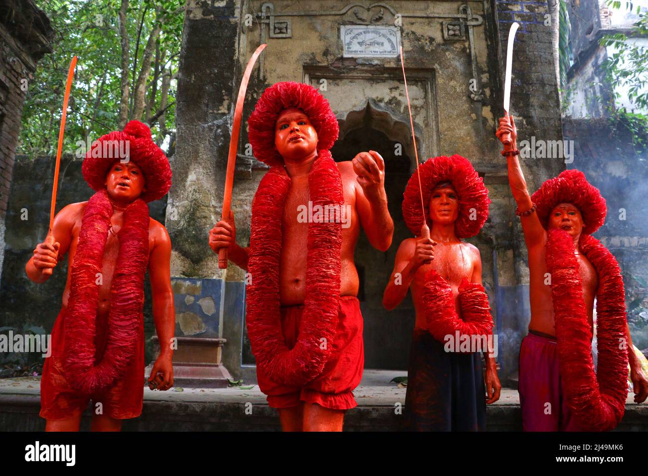 April 13, 2022, Munshiganj, Dhaka, Bangladesh: Hindu Devotees took part in the annual Lal Kach (Red Glass) festival in Munshiganj, Bangladesh to welcome Bangla new year. During the Hindu Lal Kach festival, children and men paint themselves with red color and attend a procession holding swords as they show power against evil and welcome the Bengali New Year. The Lal Kach festival is well known for the local community for more than hundred years. As the month of Chaitra, the last in the Bangla year, draws to an end, the Hindu community comes together in a festival dedicated to the worship of Lor Stock Photo