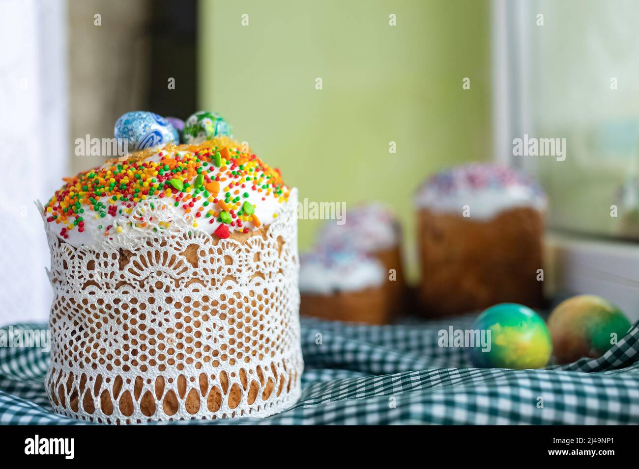 Traditional Easter cake with glace icing and painted easter eggs.Rustic style. Easter arrangement. Stock Photo