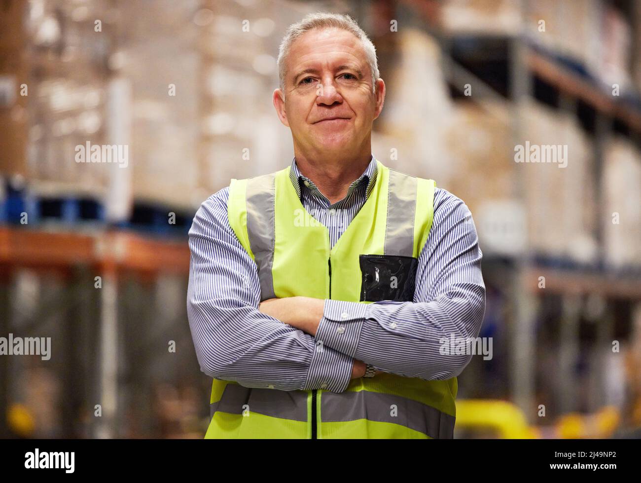 Leave it to the logistical specialist. Portrait of a mature man working in a warehouse. Stock Photo