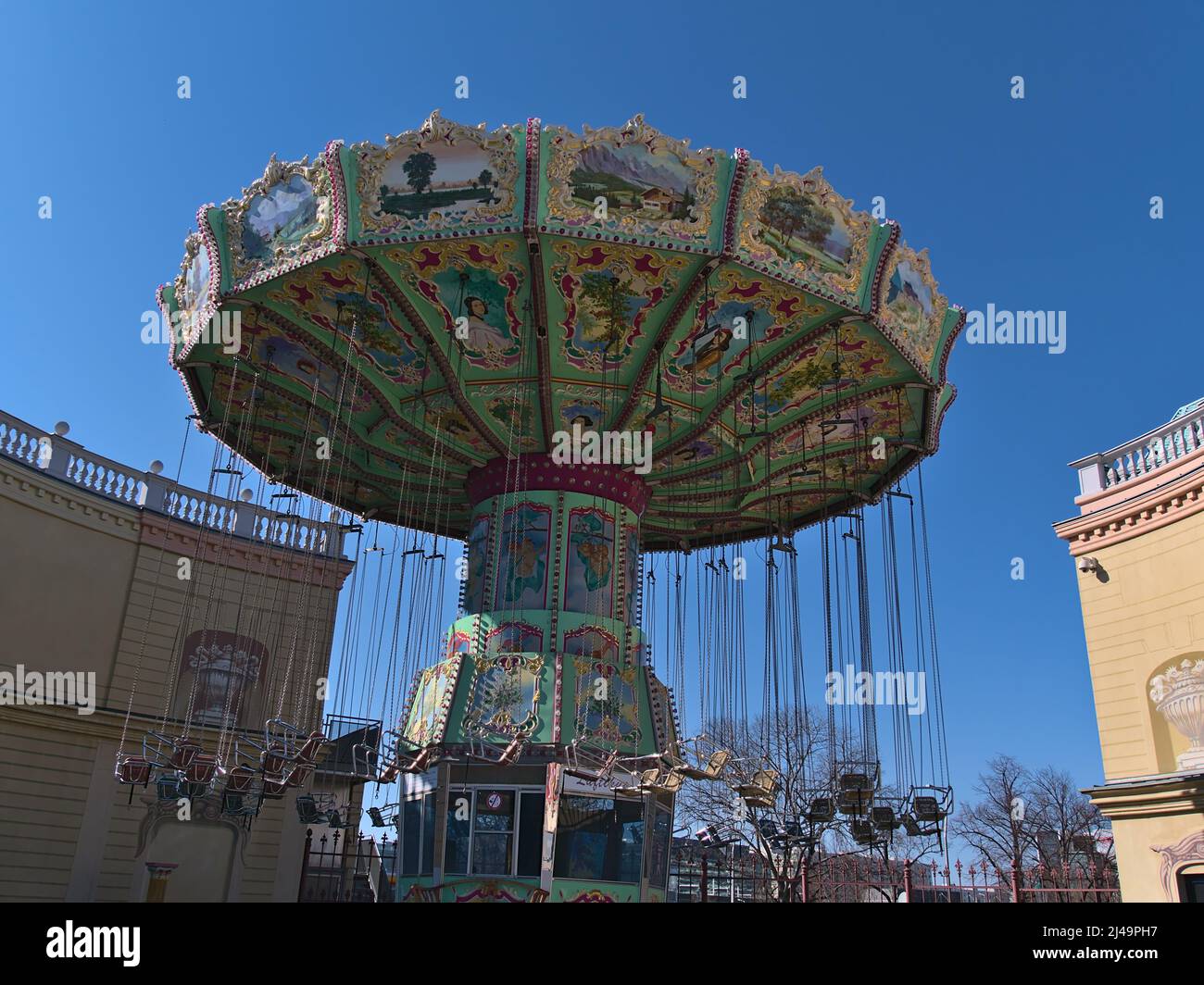 View of traditional carousel ride in amusement park Wurstelprater near Wiener Prater in Vienna, Austria on sunny day in spring season. Stock Photo