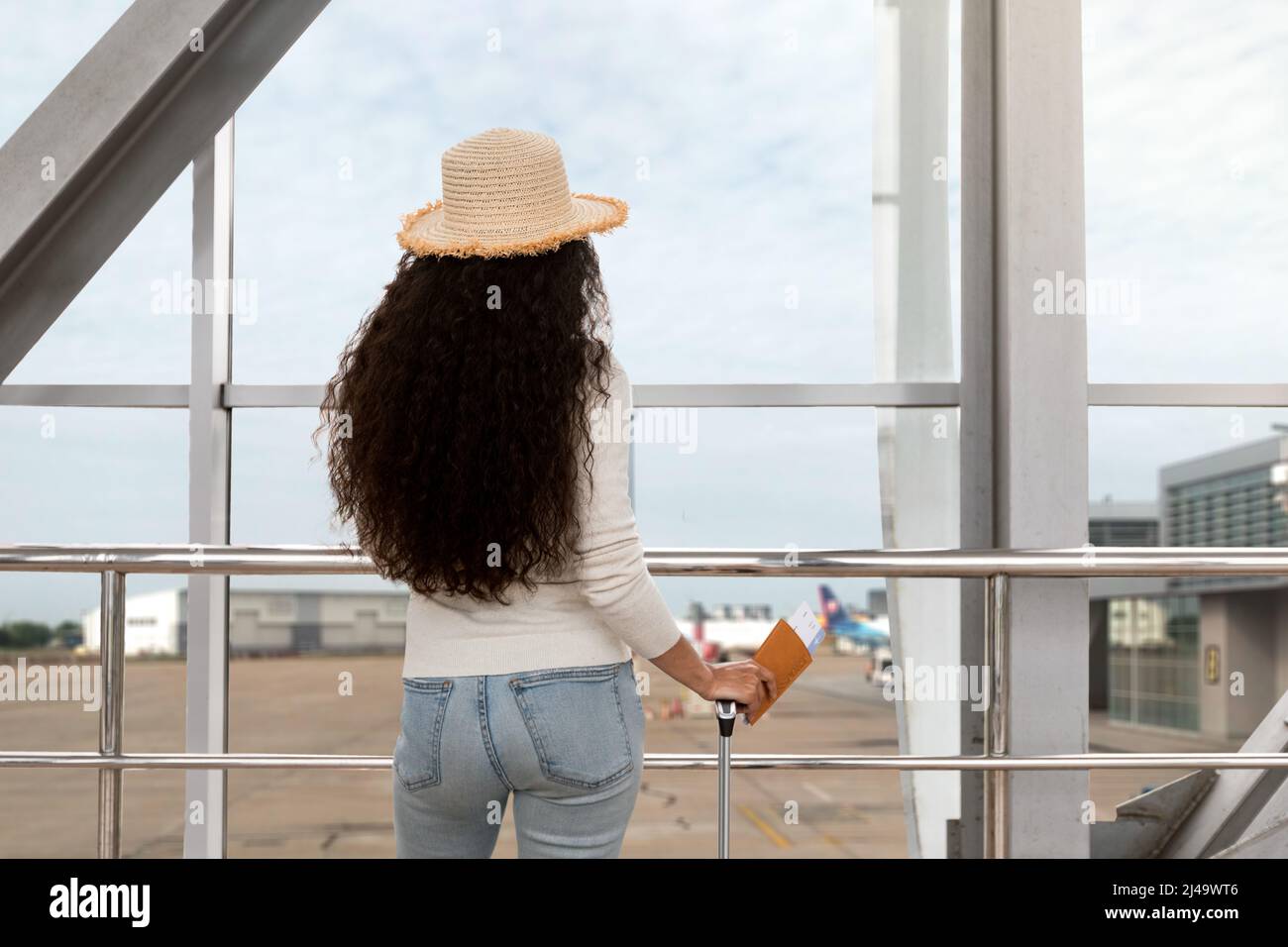 Woman airport departure window hi-res stock photography and images - Alamy