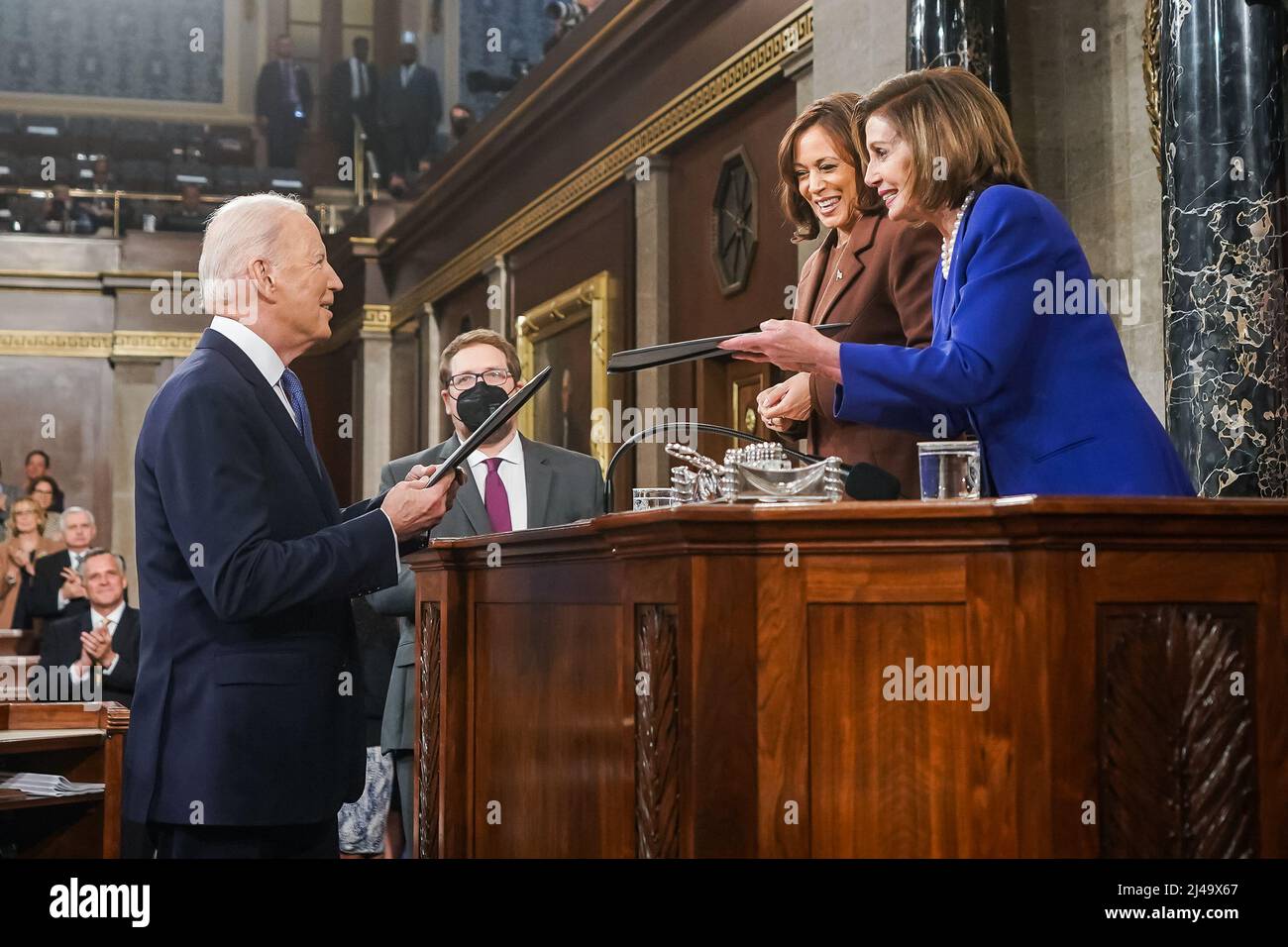 President Joe Biden presents copies of his speech to Vice President Kamala Harris and House Speaker Nancy Pelosi before delivering his State of the Union address to a joint session of Congress, Tuesday, March 1, 2022, in the House Chamber at the U.S. Capitol in Washington, D.C. (Official White House Photo by Lawrence Jackson) Stock Photo
