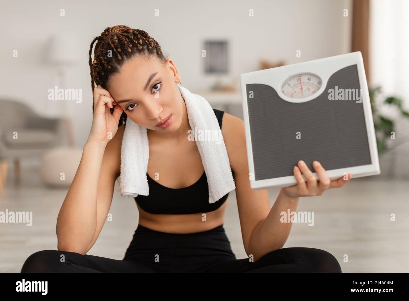Unhappy Fitness Woman Showing Scales After Unsuccessful Slimming At Home Stock Photo