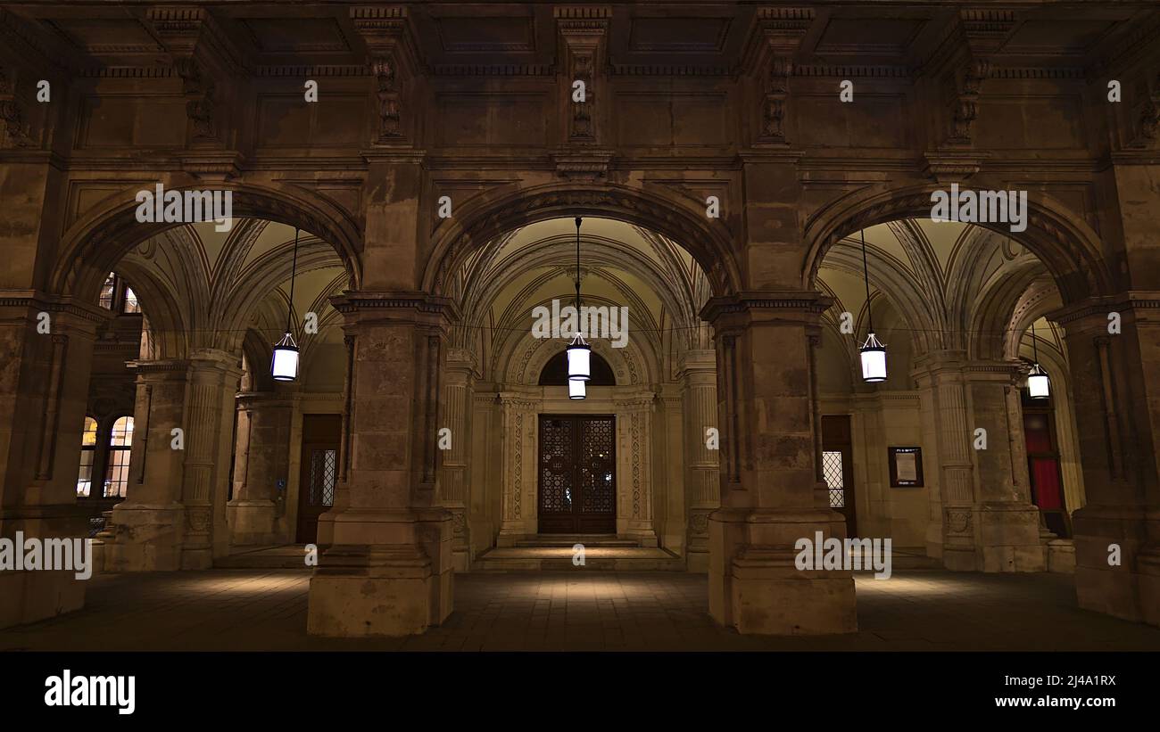 Front view of the side entrance of popular Vienna State Opera building in the old downtown of Vienna, Austria in the dark with lamps and facade. Stock Photo