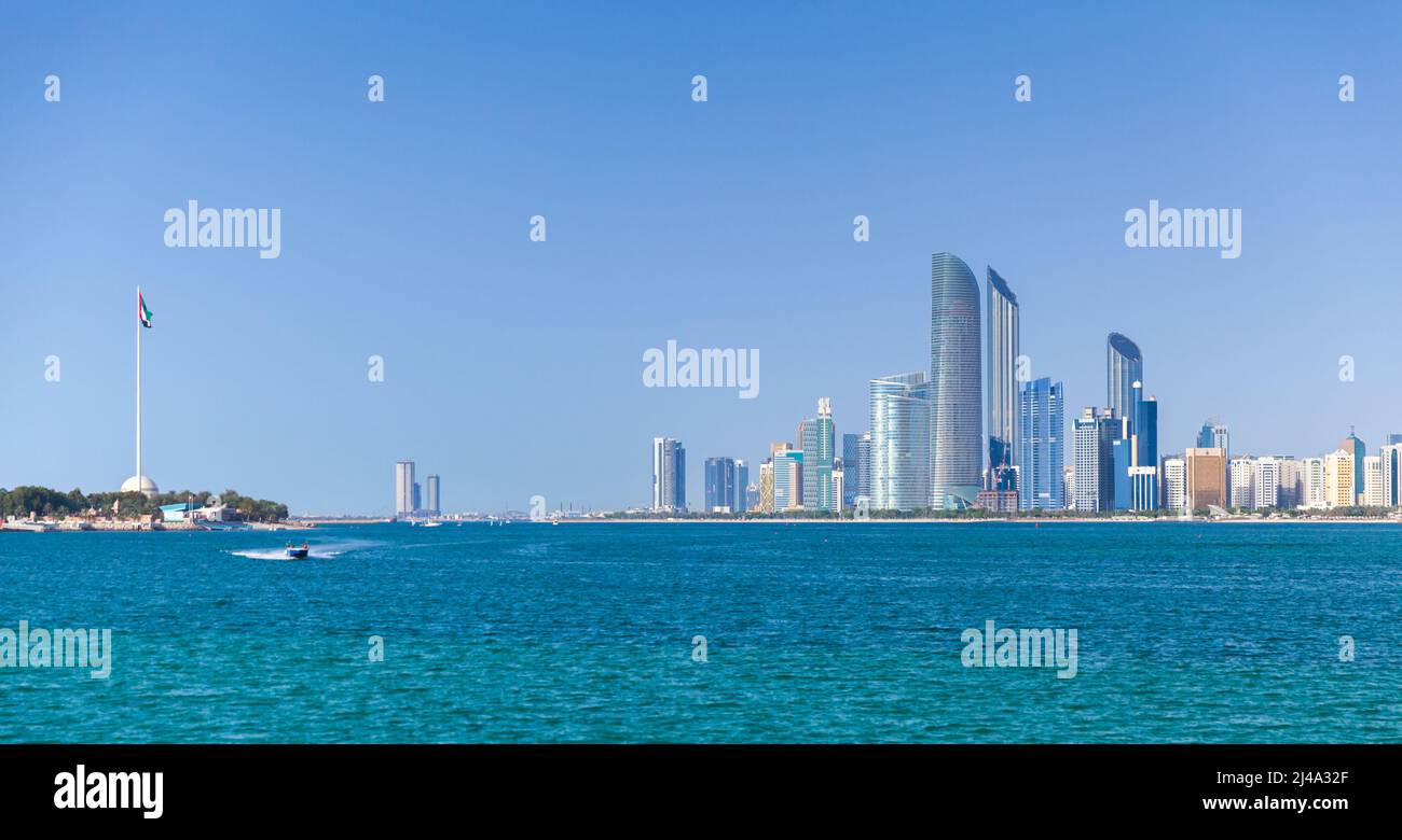 Abu Dhabi on a sunny day, cityscape with tall skyscrapers under clear blue sky Stock Photo