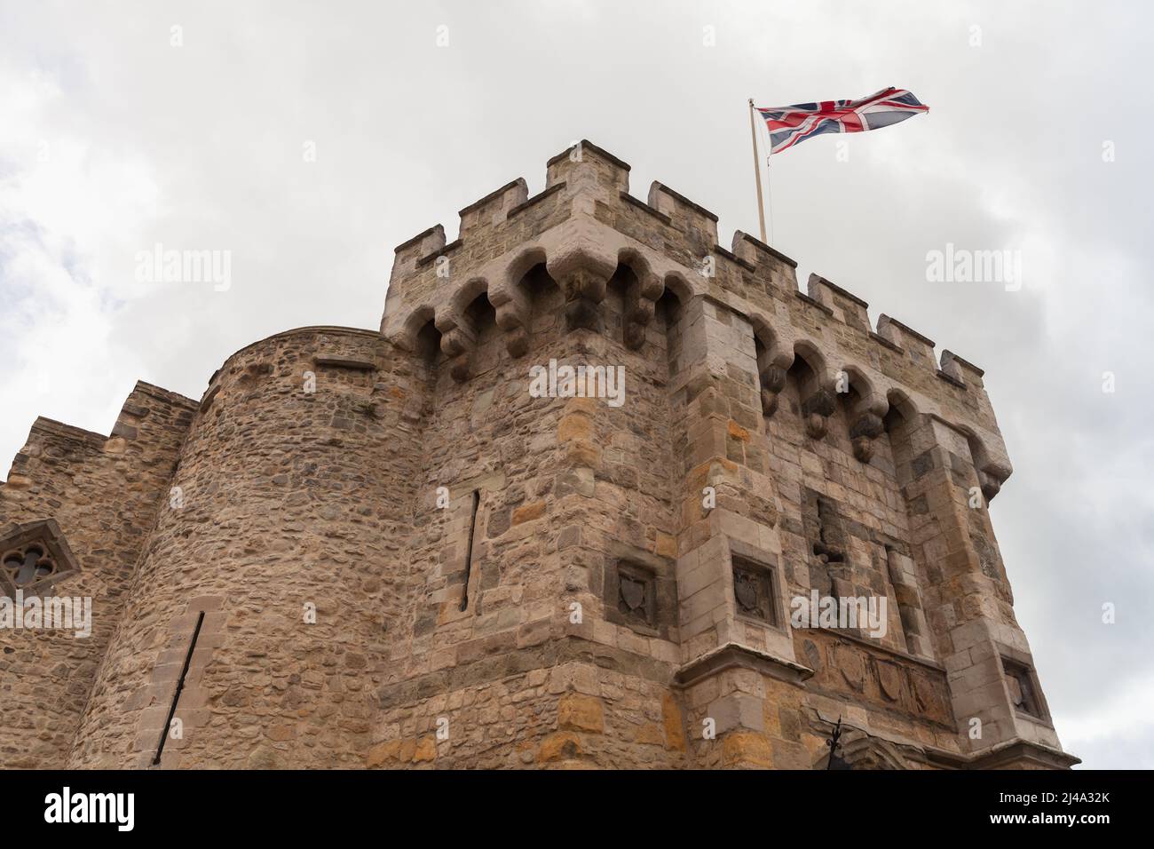 British flag is on the top of the Bargate. It is a medieval gatehouse in the city of Southampton, England. Constructed in Norman times as part of the Stock Photo