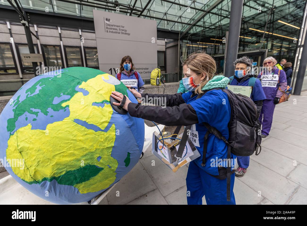 Environmental protesters outside government buildings in Whitehall demonstrating against the global warming and use of fossil fuels, London, UK Stock Photo