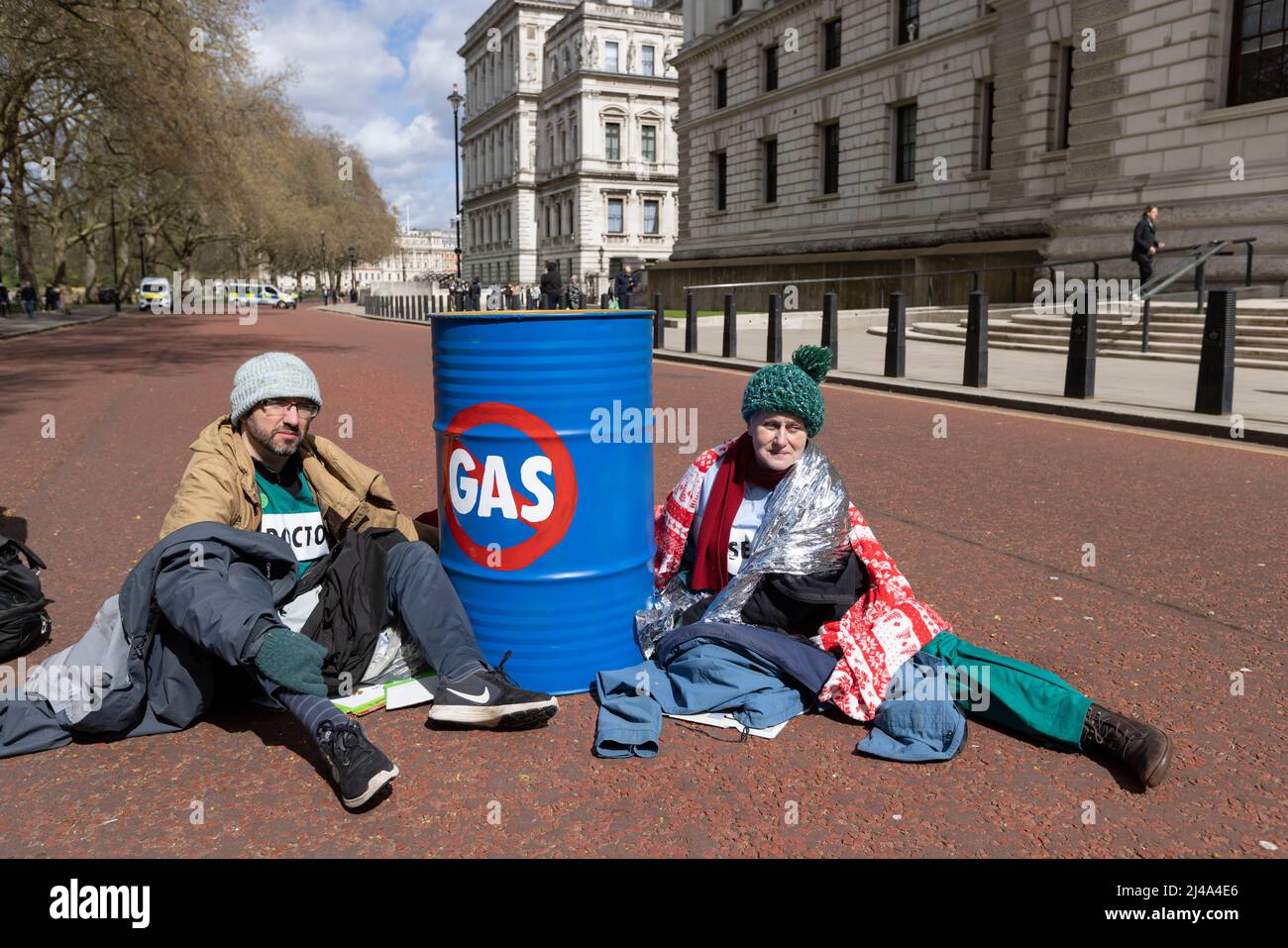 Environmental protesters outside government buildings in Whitehall demonstrating against the global warming and use of fossil fuels, London, UK Stock Photo