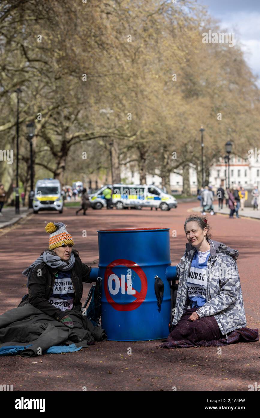 Environmental protesters outside government buildings in Whitehall demonstrating against the global warming and use of fossil fuels, London, UK Stock Photo