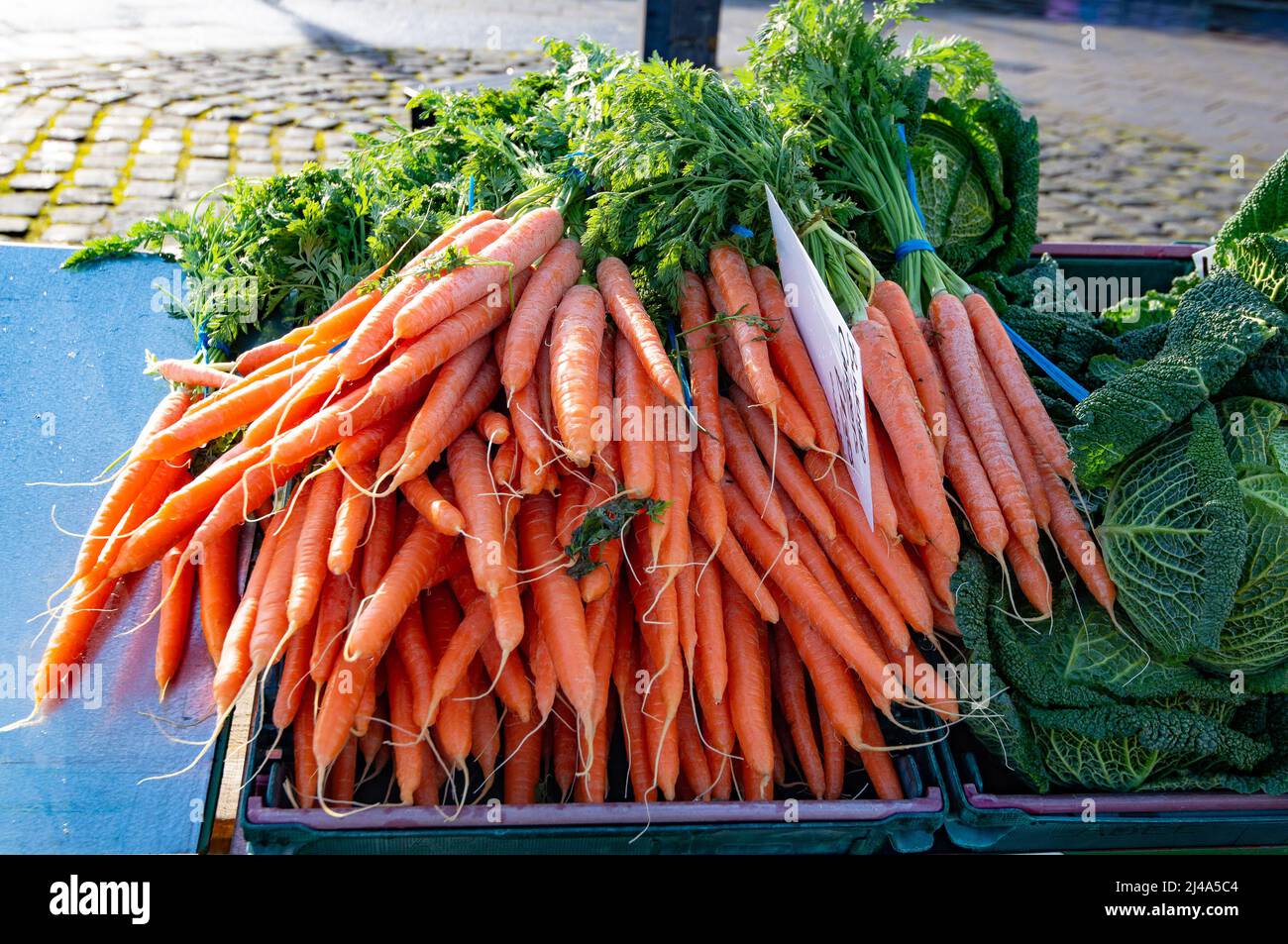 A bunch of carrots on a market stall, Clitheroe market, Clitheroe, Lancashire, UK. Stock Photo