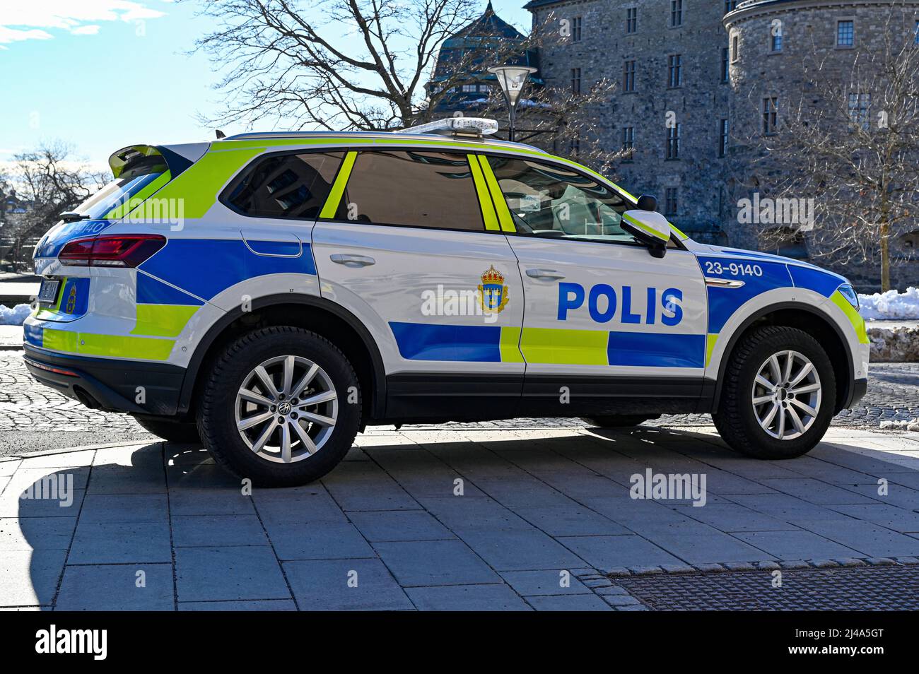 Swedish patrol car parked infront of Orebro Castle downtown Orebro Sweden april 11 2022 Stock Photo