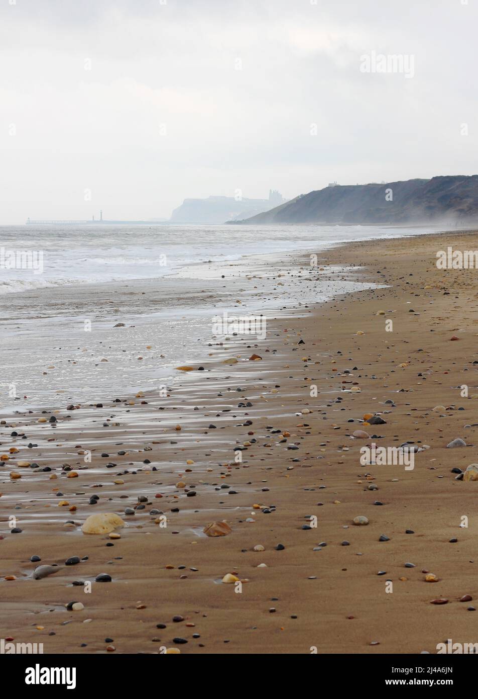 View to Whitby Abbey from Sandsend beach on an overcast day Stock Photo
