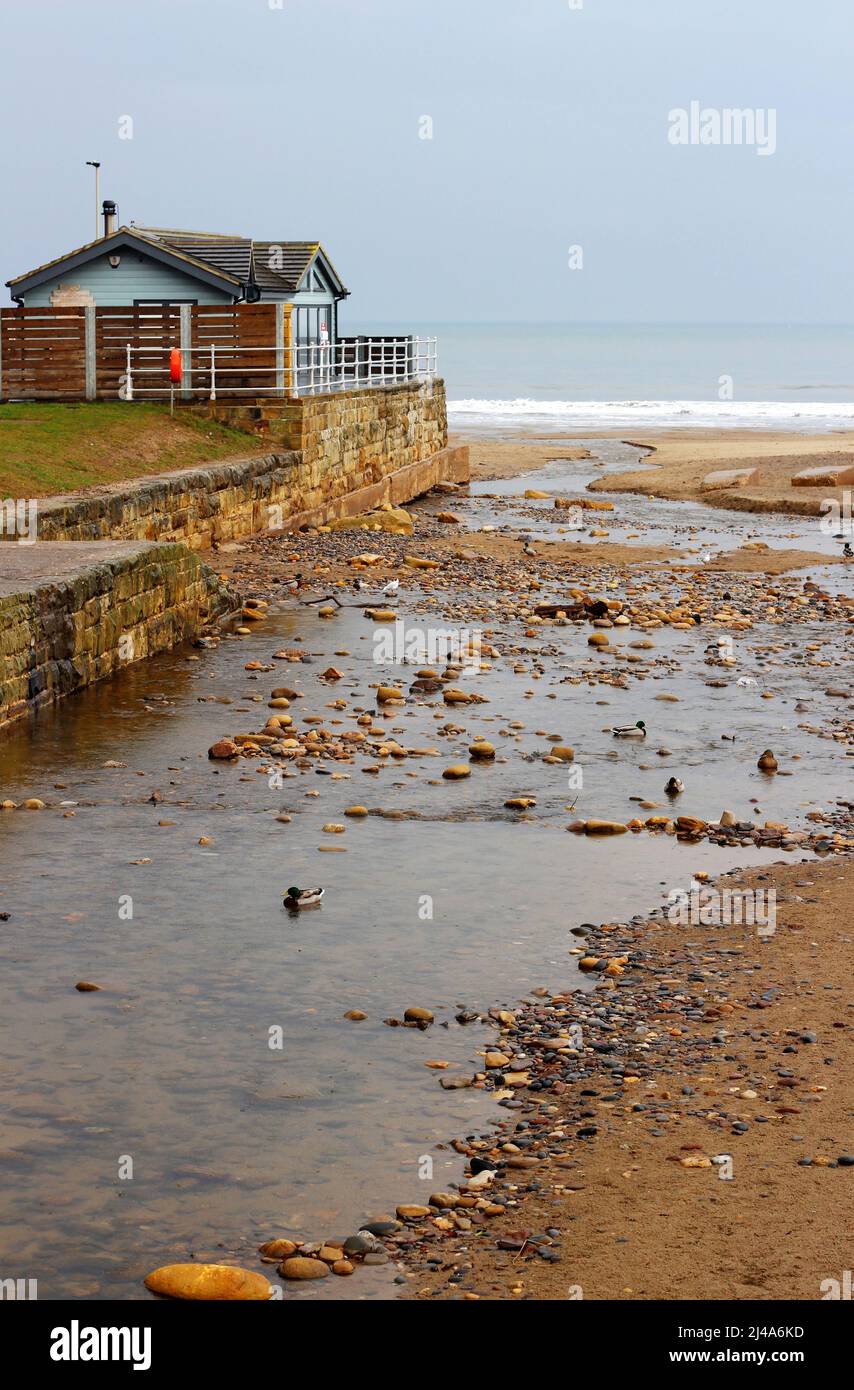 Water trickling into the sea in Sandsend, Yorkshire Stock Photo