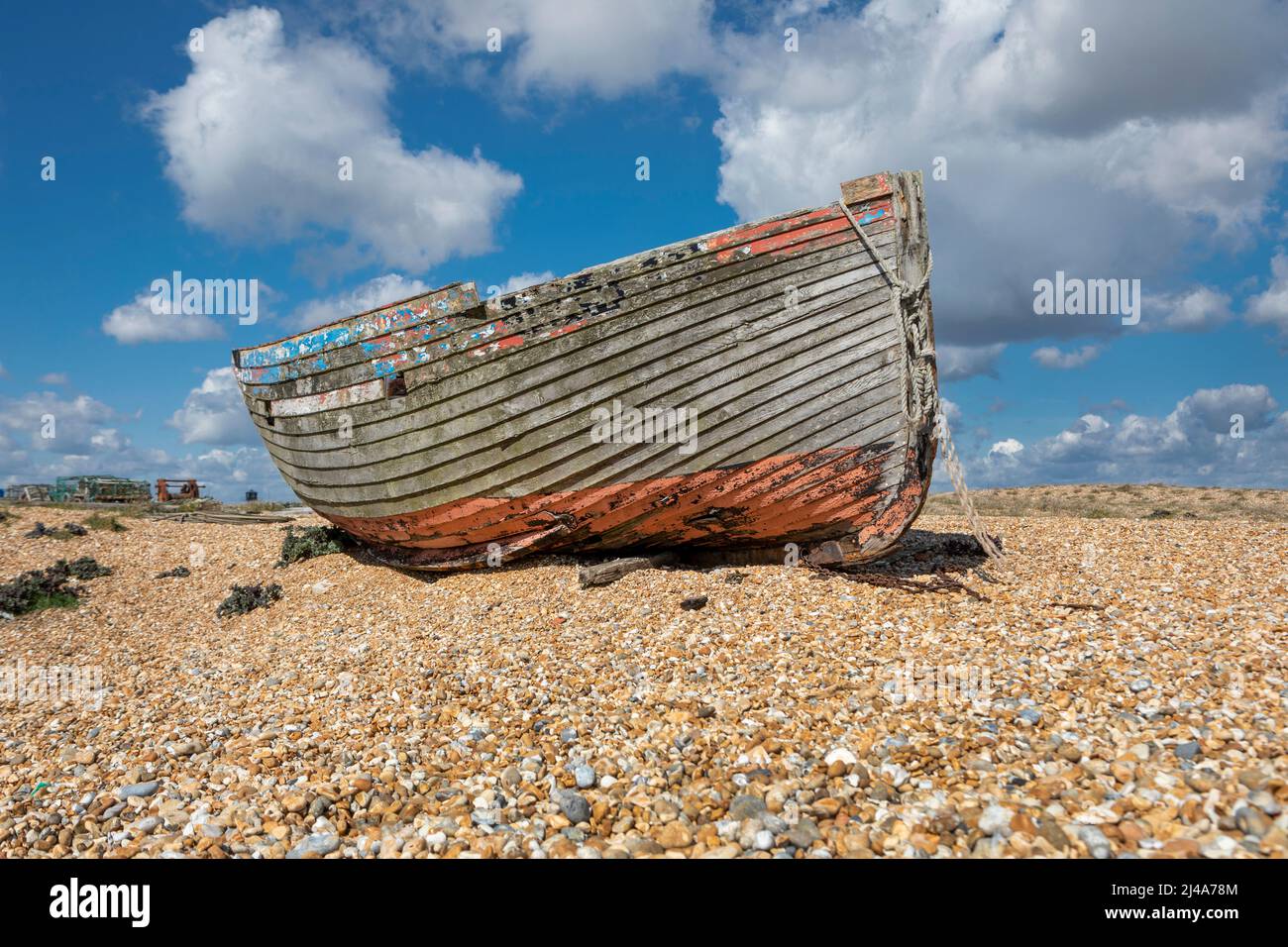 An old abandoned wooden fishing boat on a shingle beach Stock Photo - Alamy