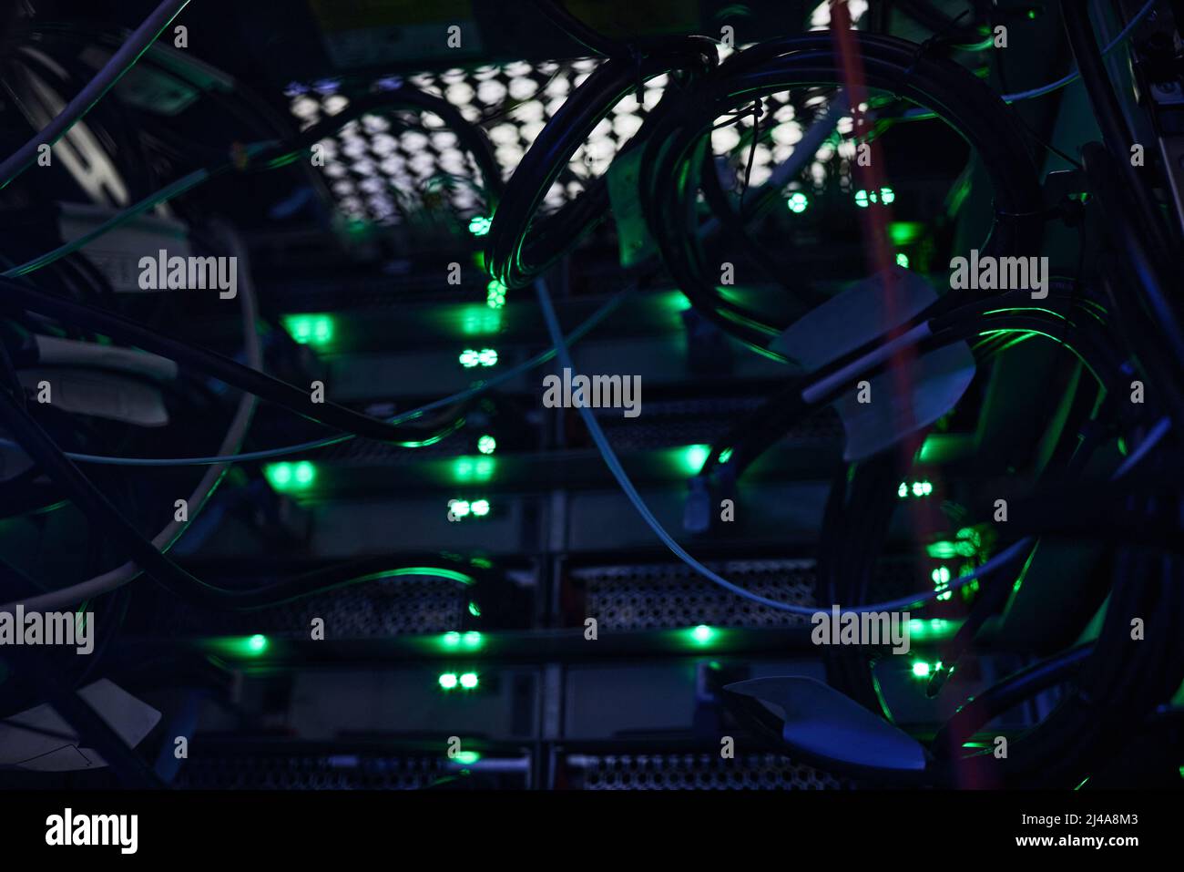 All systems go. Cropped shot of a large, dark and empty server room. Stock Photo