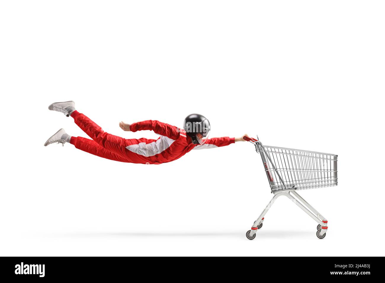 Car racer in a red suit and black helmet flying with an empty shopping cart isolated on white background Stock Photo