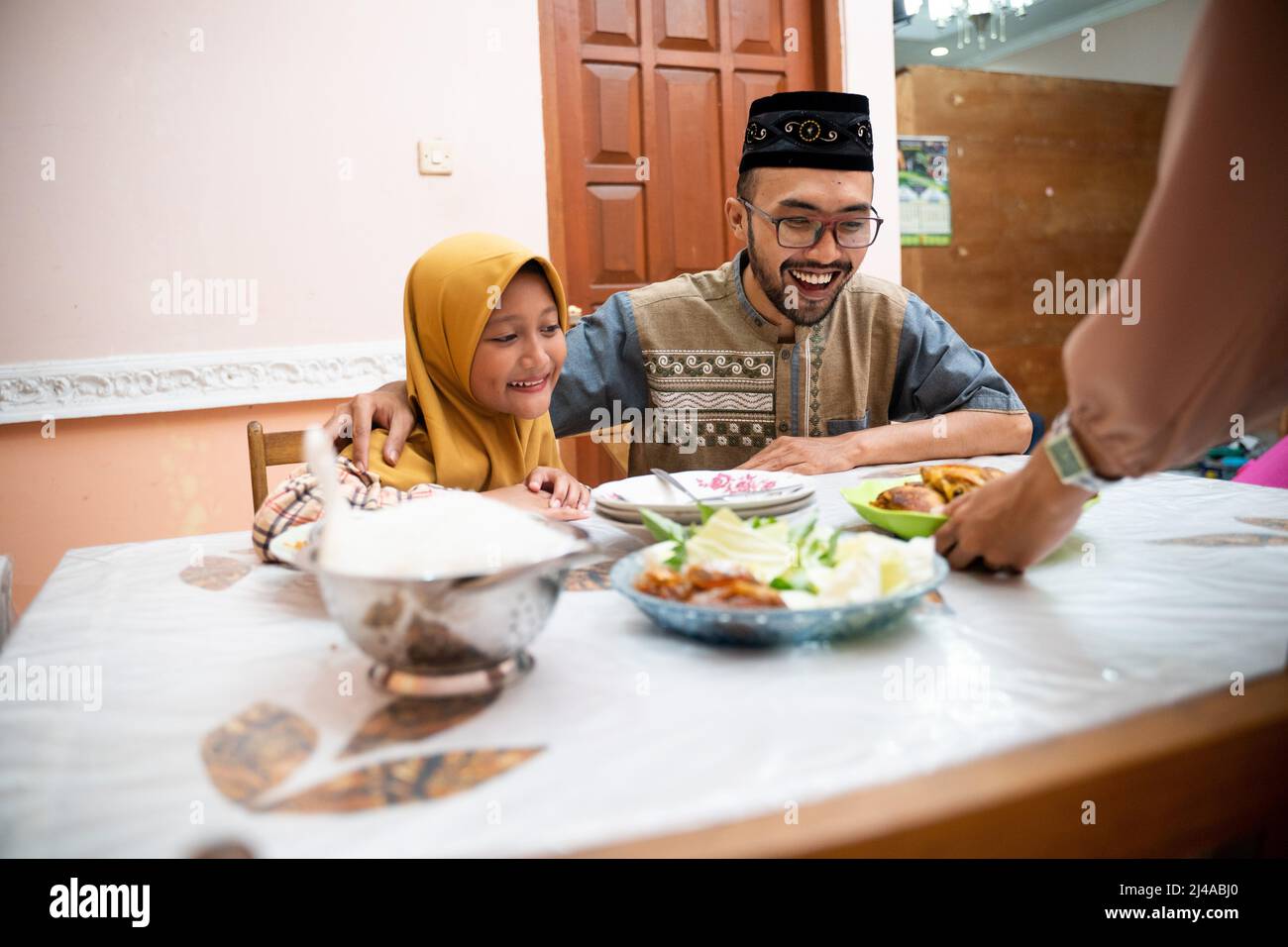muslim father and daughter during iftar dinner on ramadan kareem Stock Photo